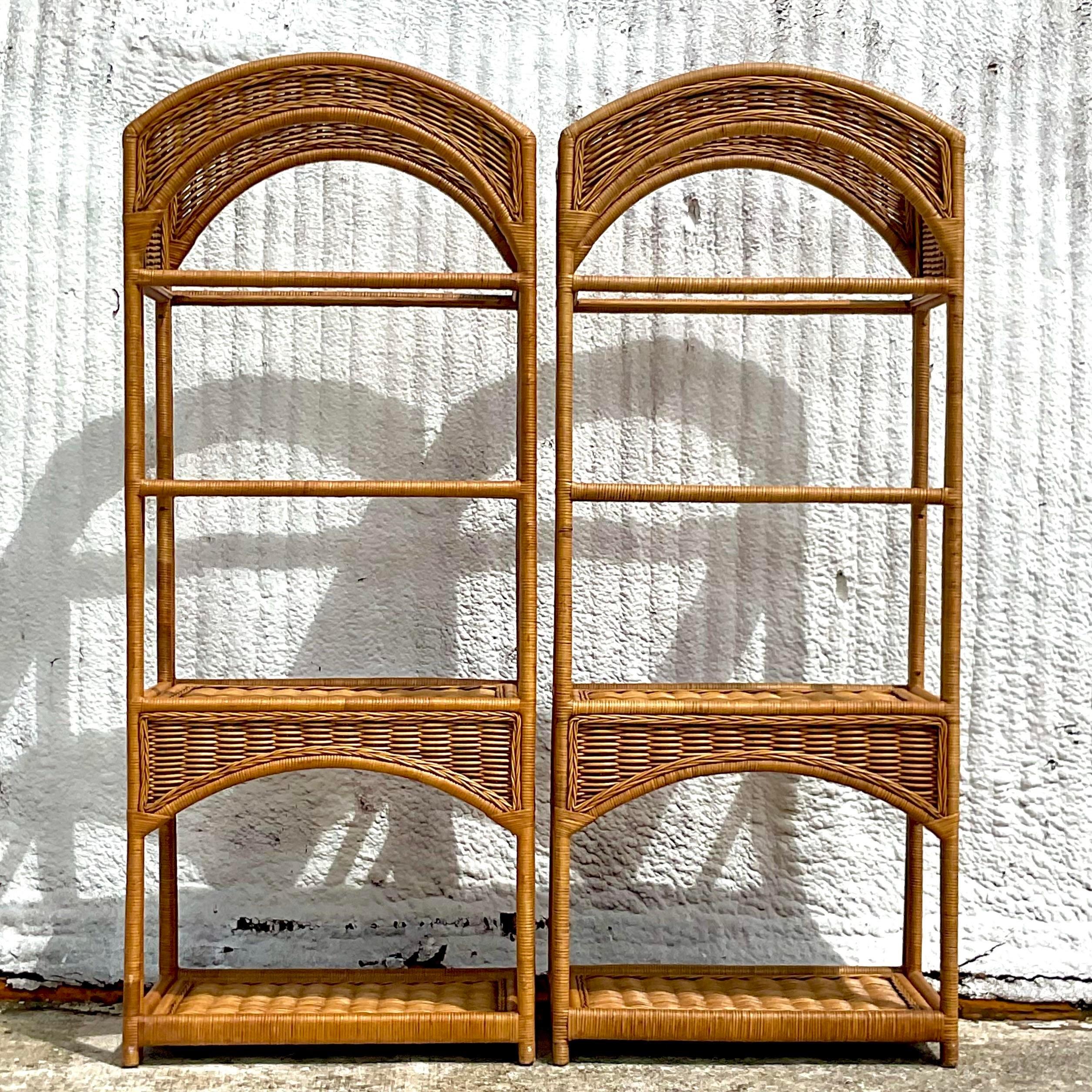 Fantastic pair of vintage Coastal etagere. Beautiful arched design with inset glass shelves. Beautiful in their simplicity. Acquired from a Palm Beach estate.