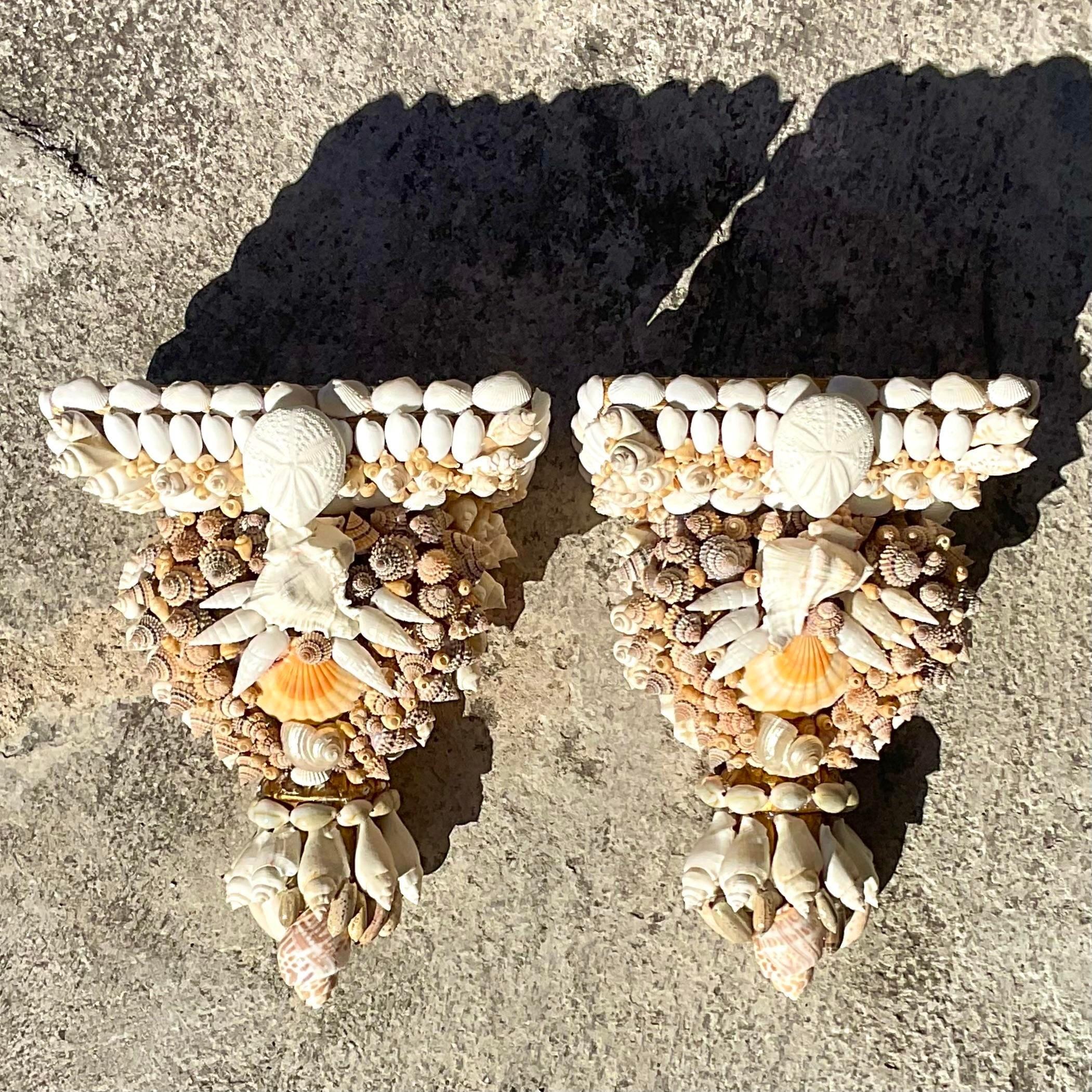 A stunning pair of vintage Coastal decorative wall brackets. Artisan made shell finish using beautiful vintage shells. Acquired from a Palm Beach estate.