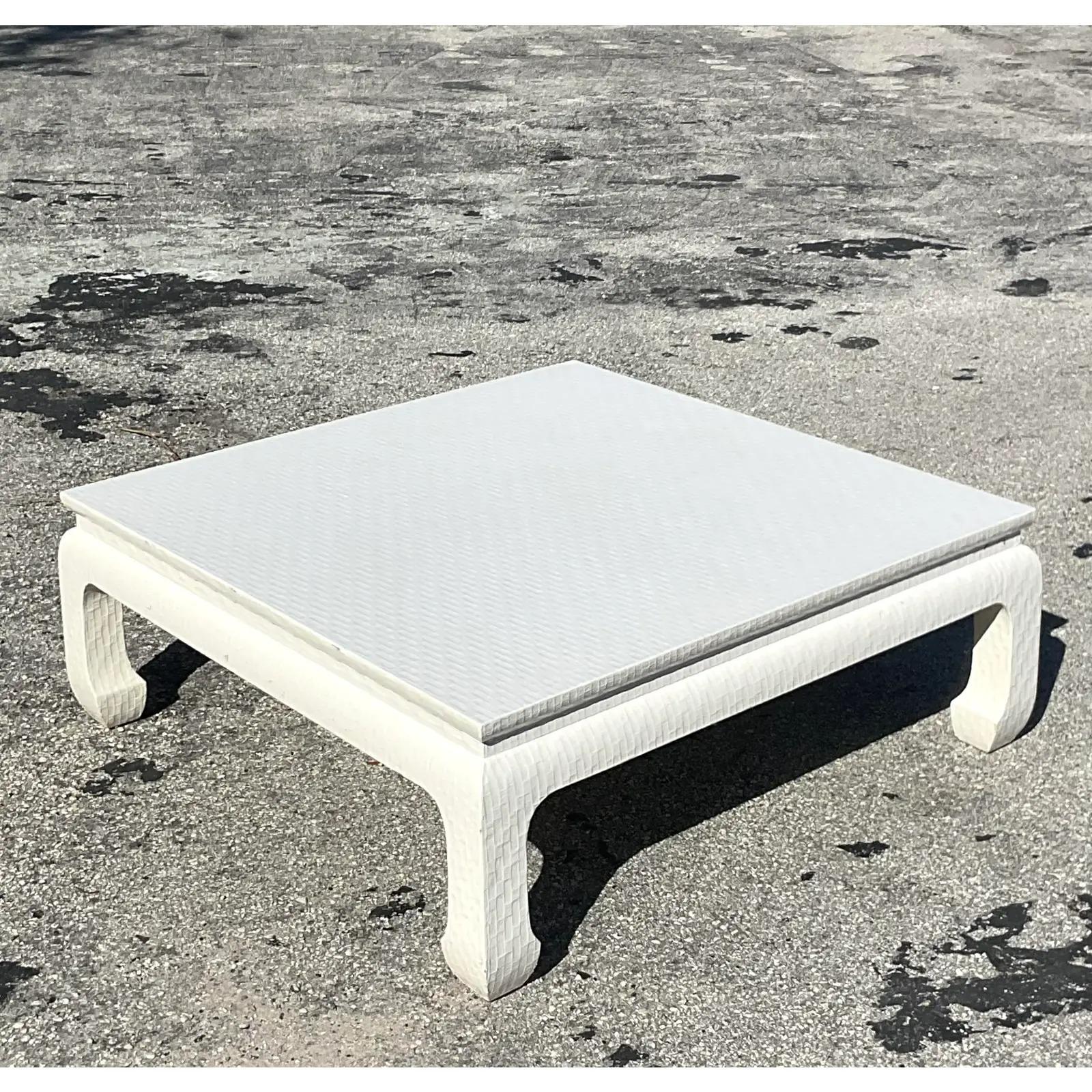 A fabulous vintage coastal coffee table. Made by the iconic Baker Furniture group. Beautiful lacquered Grasscloth in a gloss ivory shade. Marked on the bottom. Acquired from a Palm Beach estate.