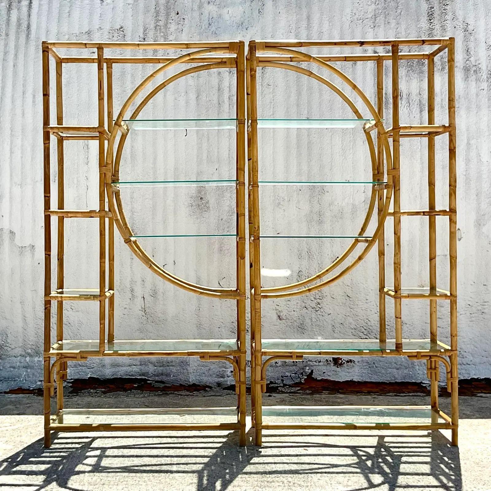 A fantastic pair of vintage Coastal Etagere. Beautiful bamboo frame with a distinctive circle design in the center. Dramatic, yet subtle at the same time. Inset glass shelves. Acquired from a Palm Beach estate.