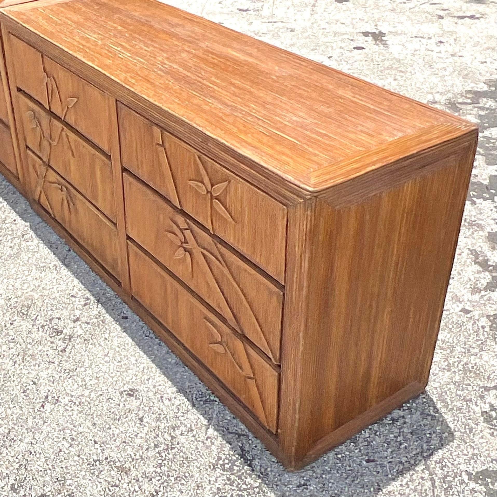 Elevate your bedroom décor with this Vintage Coastal Bamboo Shoots Pencil Reed Dresser. Featuring intricate pencil reed detailing and a relaxed coastal vibe, this dresser combines natural materials with classic American craftsmanship, perfect for