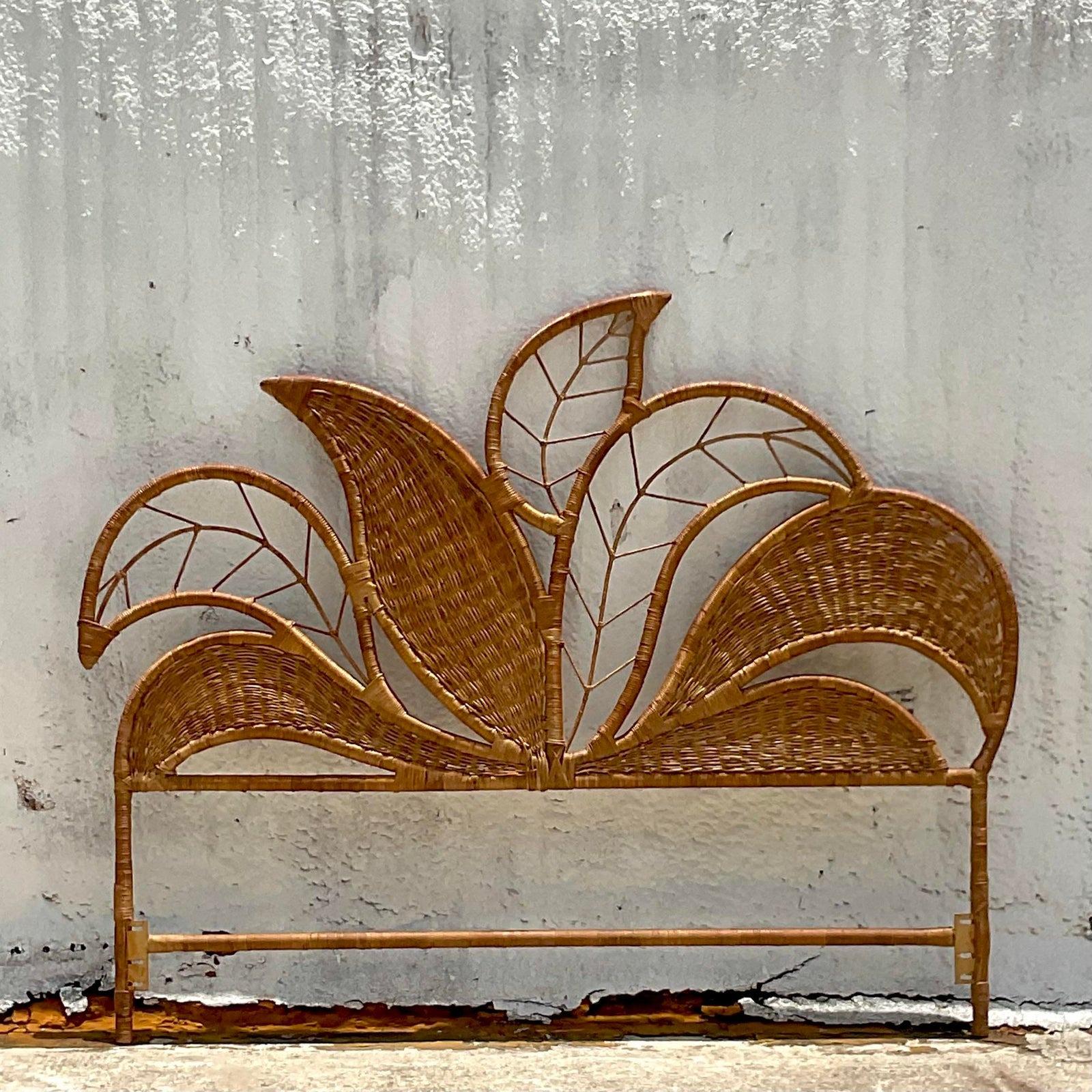 A fantastic vintage Costal Queen headboard. Beautiful wrapped rattan with a banana leaf motif. Acquired from a Palm Beach estate.