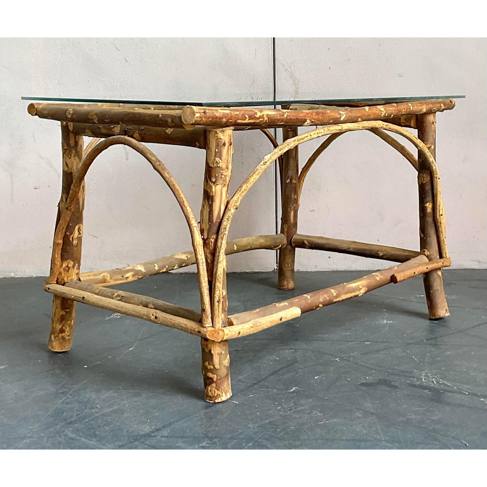 Discover the organic charm of this vintage bent branch coffee table, a captivating piece that effortlessly marries rustic allure with a coastal sensibility. Crafted from natural branches, its unique construction showcases an artistic use of organic