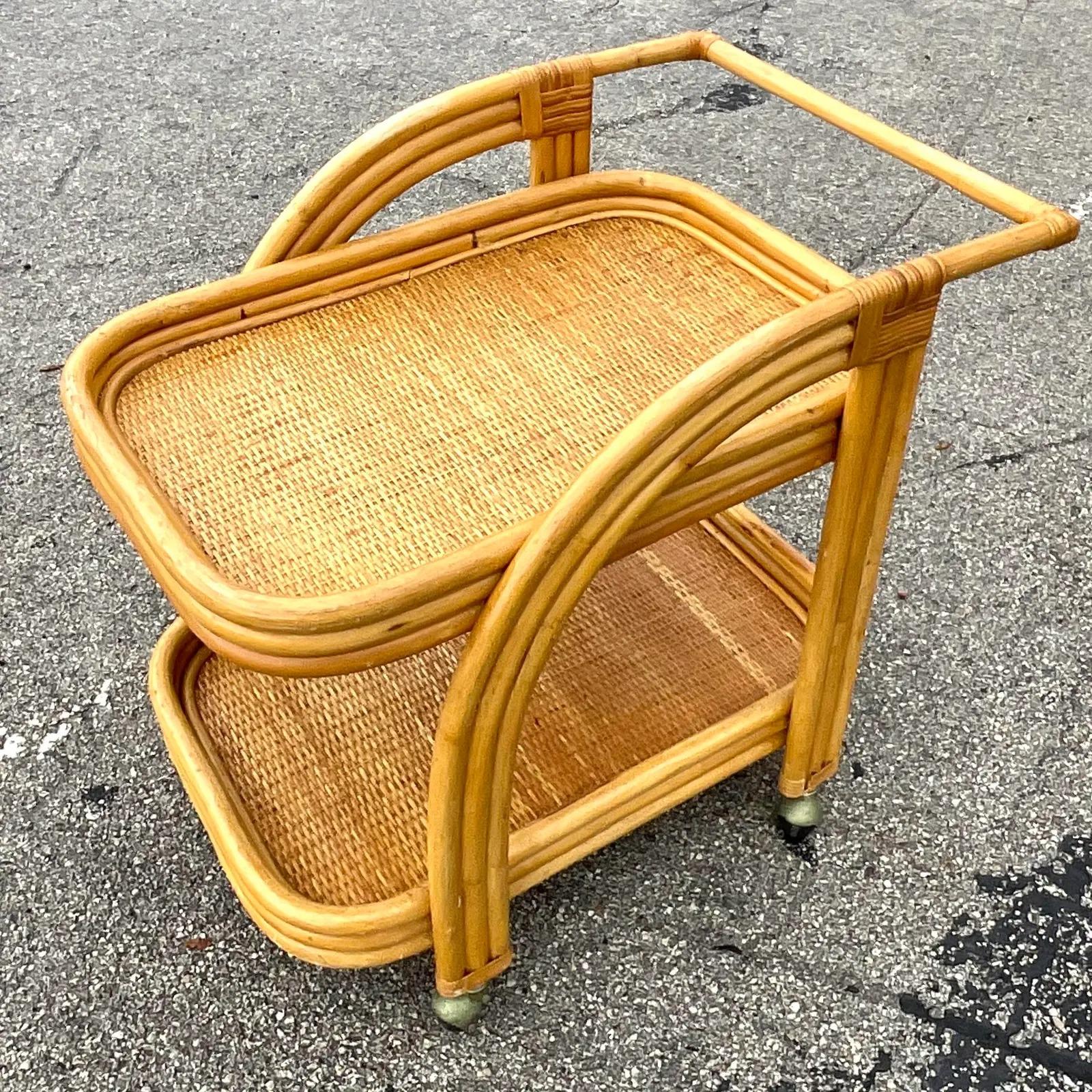 A fabulous vintage Coastal bar cart. Beautiful bent rattan frame with inset woven rattan panels. Acquired from a Palm Beach estate.