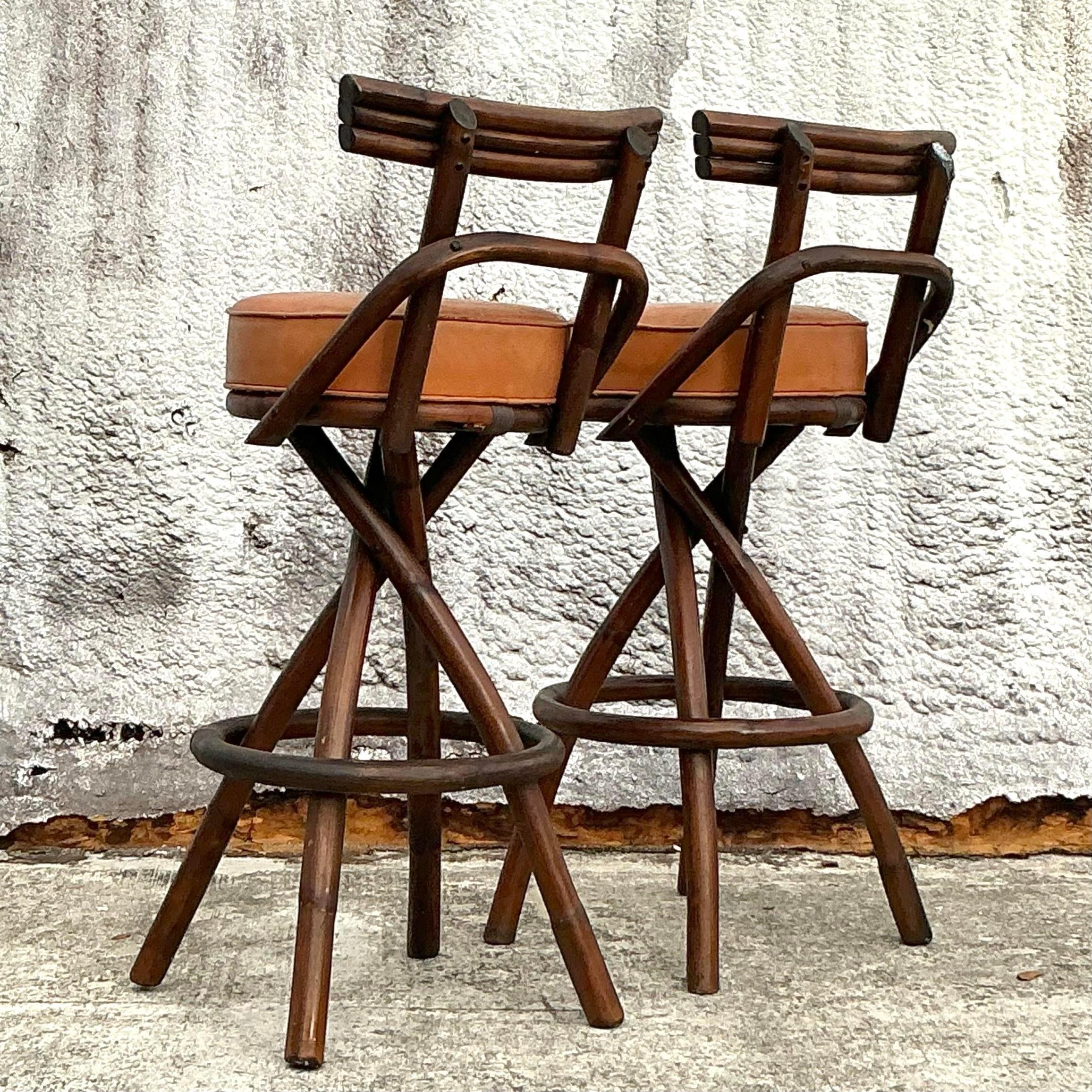 This pair of vintage coastal barstools brings easygoing elegance with their bent rattan frames and woven seats. Perfect for adding a hint of tropical charm, each stool is sturdy yet lightweight, making them ideal for kitchen islands, breakfast