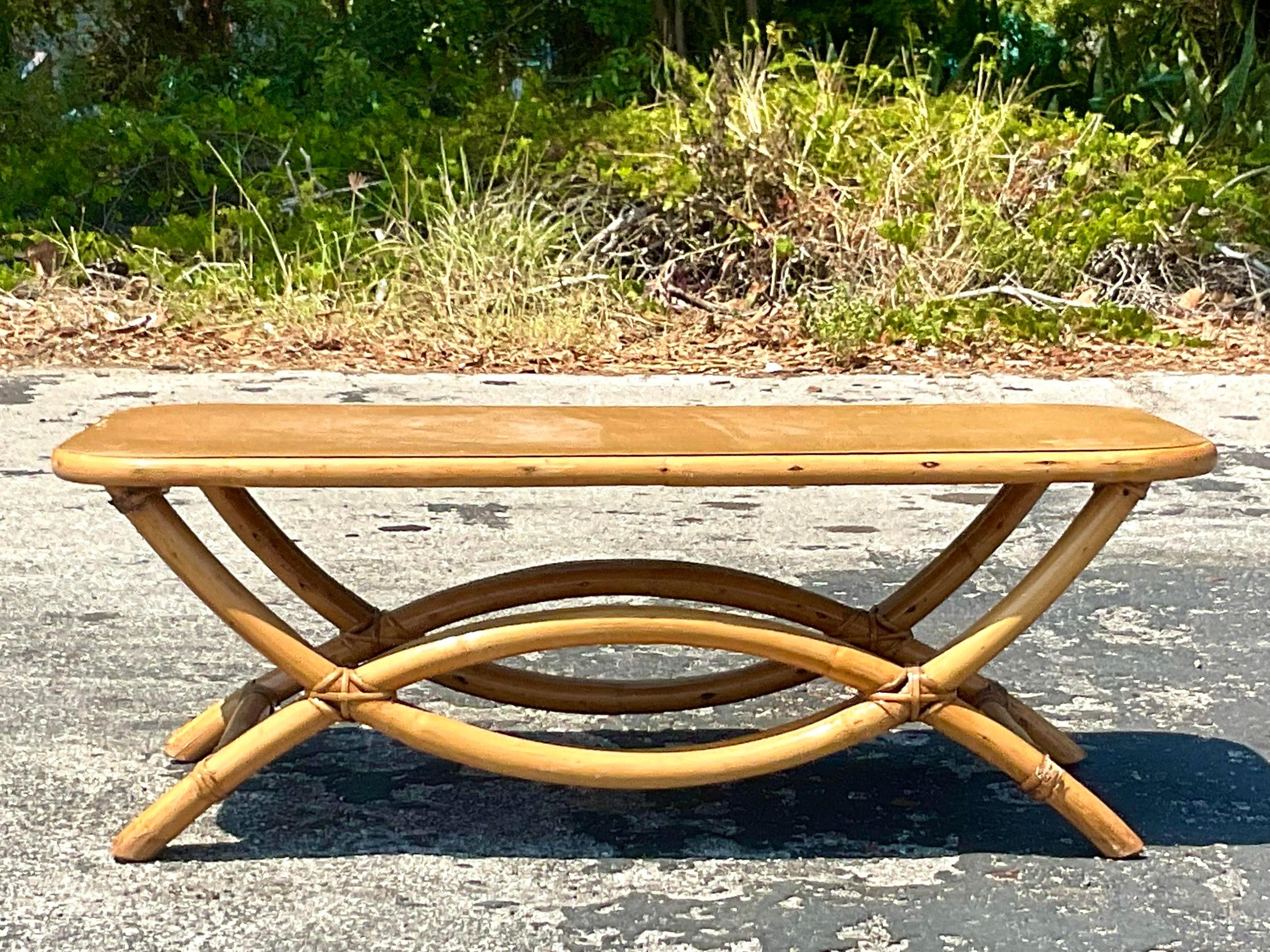 A fabulous vintage Coastal coffee table. Chic bent rattan in a loop design. Acquired from a Palm Beach estate.