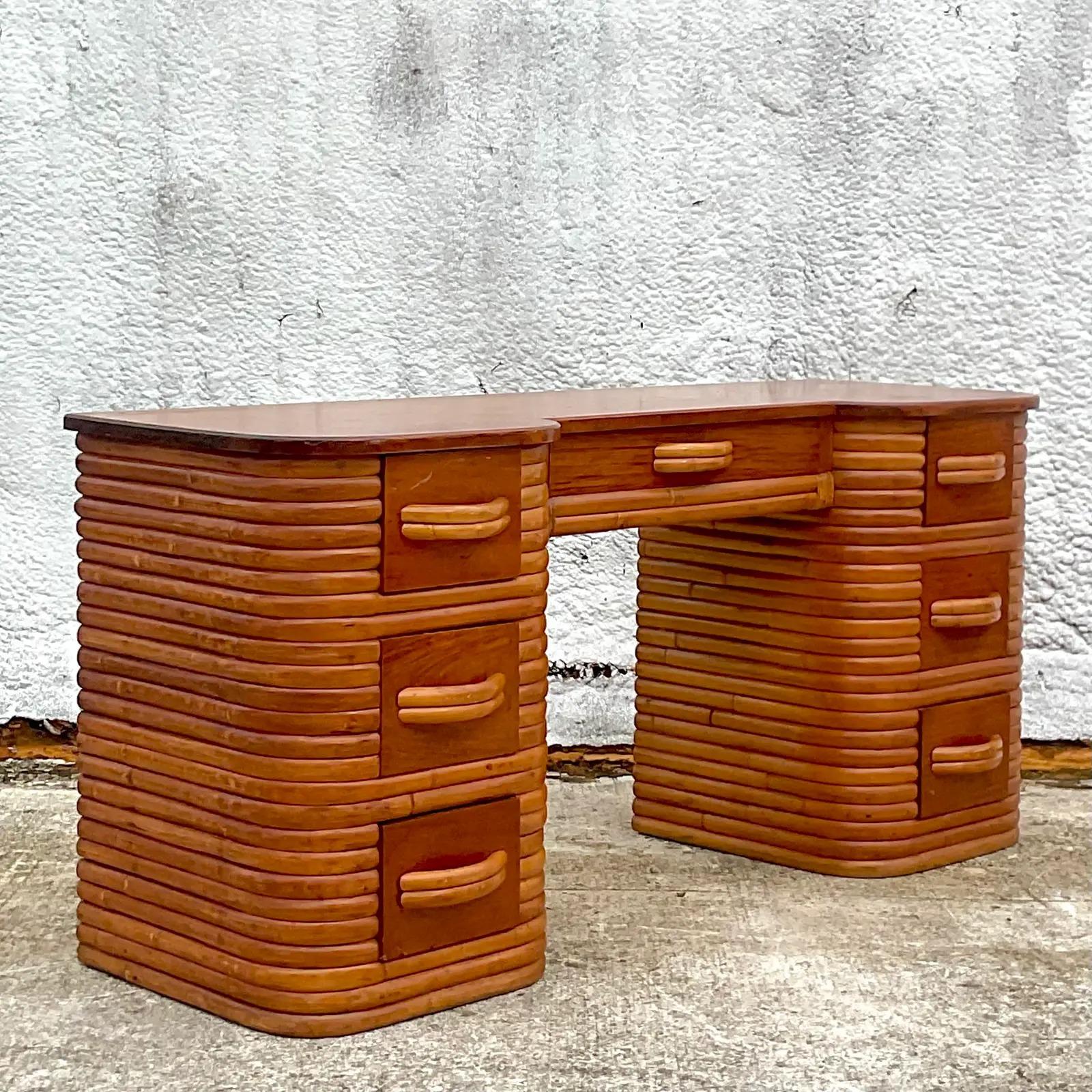 A fantastic vintage Coastal writing desk. Beautiful stacked rattan in a chic curved design. Stacked rattan in a warm caramel color. Acquired from a Palm Beach estate.