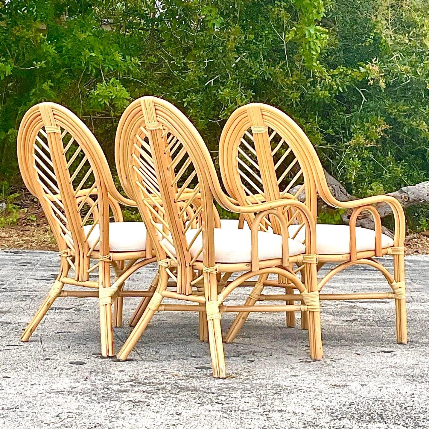 Elevate your dining experience with this set of 4 Vintage Coastal Bent Rattan Dining Chairs. Perfectly embodying American style, these chairs blend natural elegance with coastal charm, offering both comfort and timeless appeal. Ideal for creating a