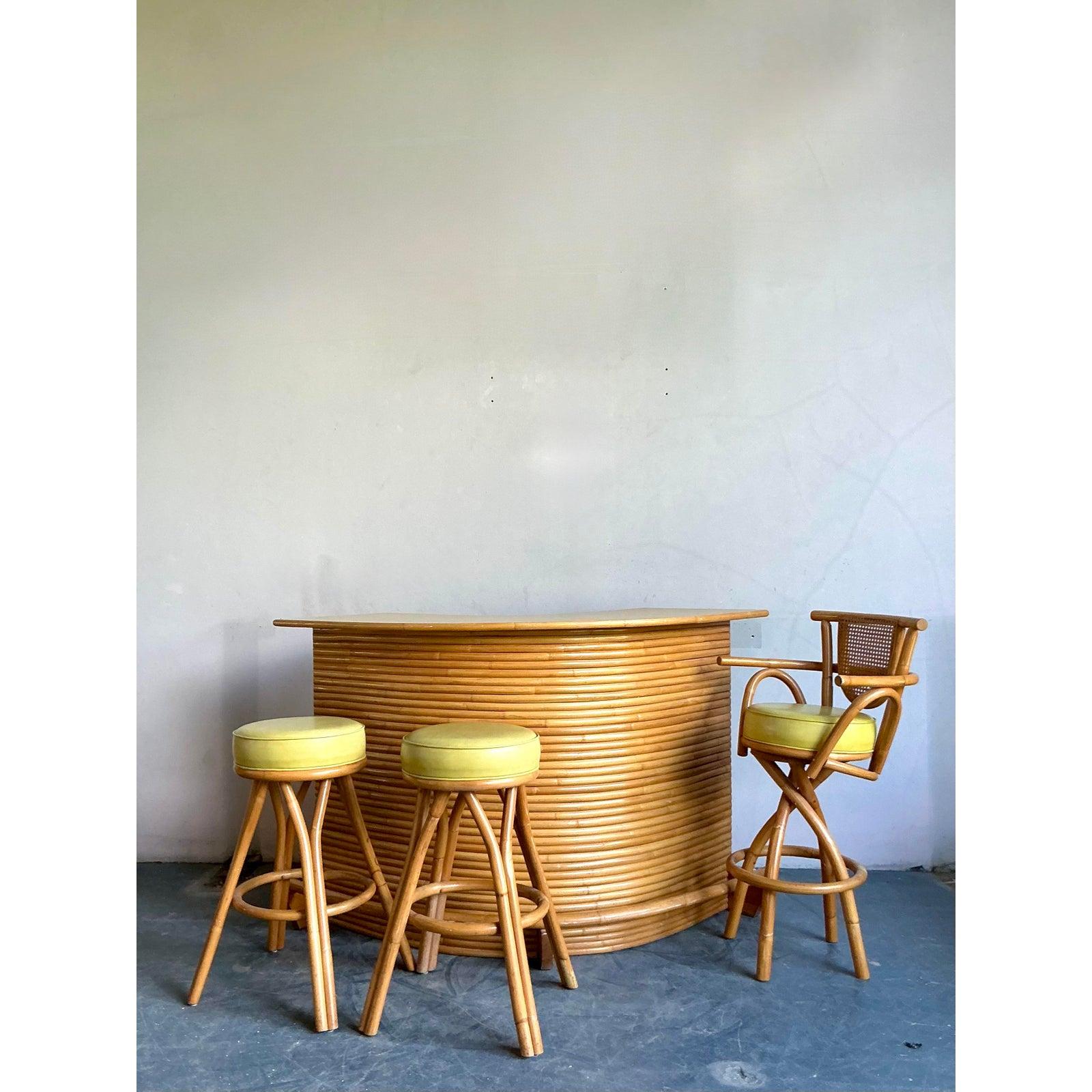 Channel the effortless glamour of a tropical resort with this magnificent vintage rattan bar. Masterfully designed with a dramatic kidney-shaped curve, its facade is meticulously wrapped in stacked pencil reed, creating a stunning linear and