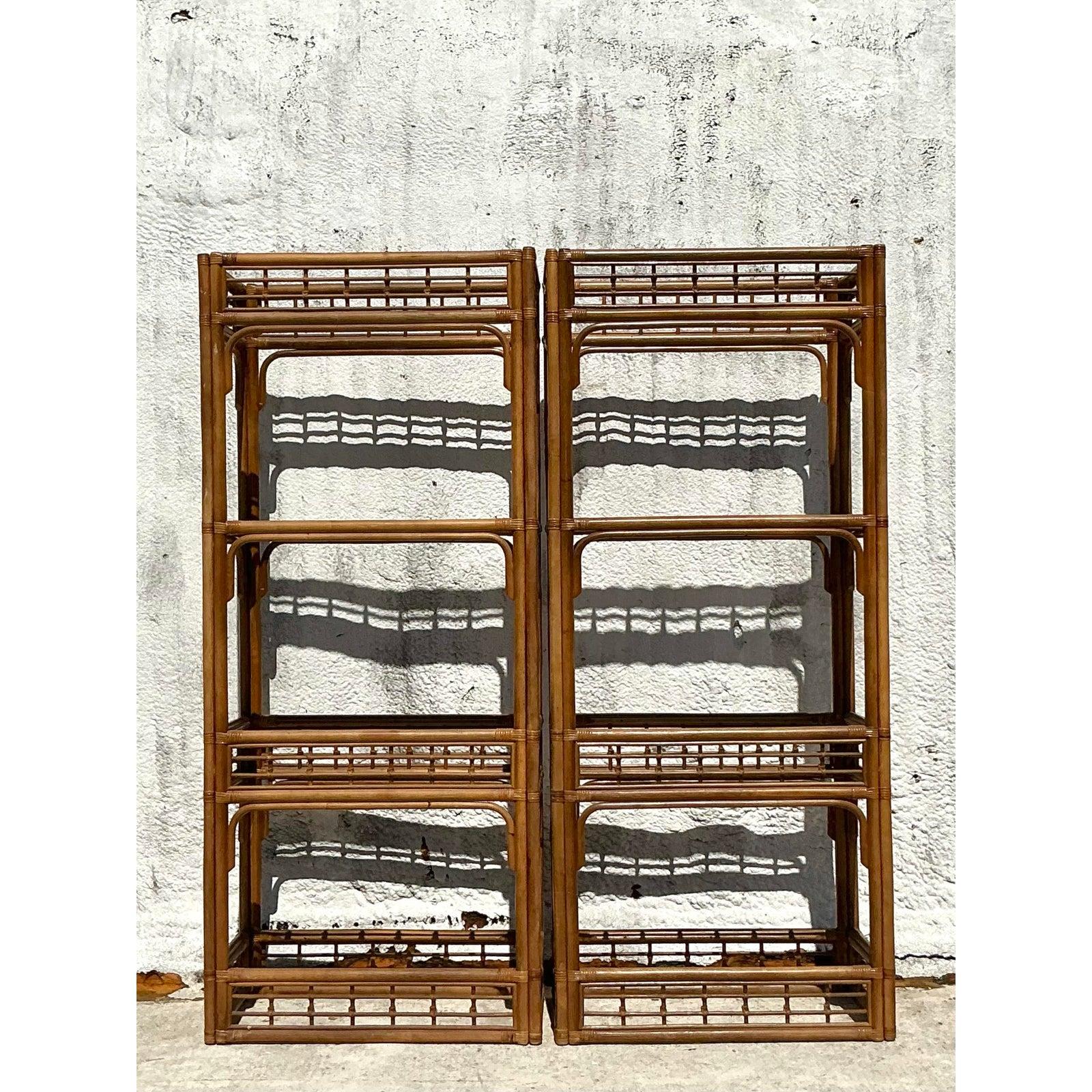 Elevate your interior with this charming pair of vintage etageres, expertly crafted from beautifully bent rattan. Each piece features a tall, open frame with multiple inset glass shelves, showcasing the natural elegance and graceful curves inherent