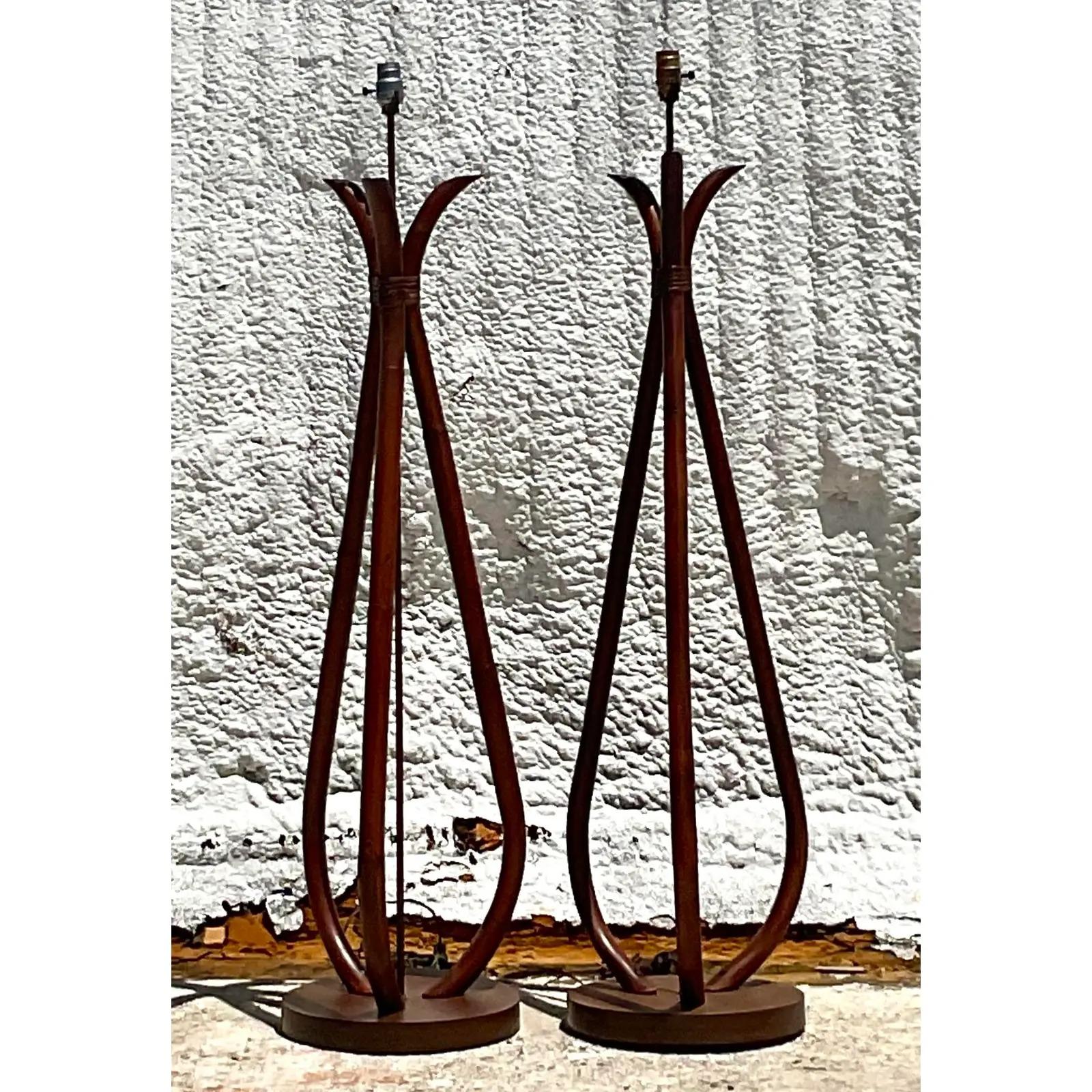 A fantastic pair of vintage Coastal floor lamps. Beautiful bent rattan in a clean and modern design. Acquired from a Palm Beach estate.