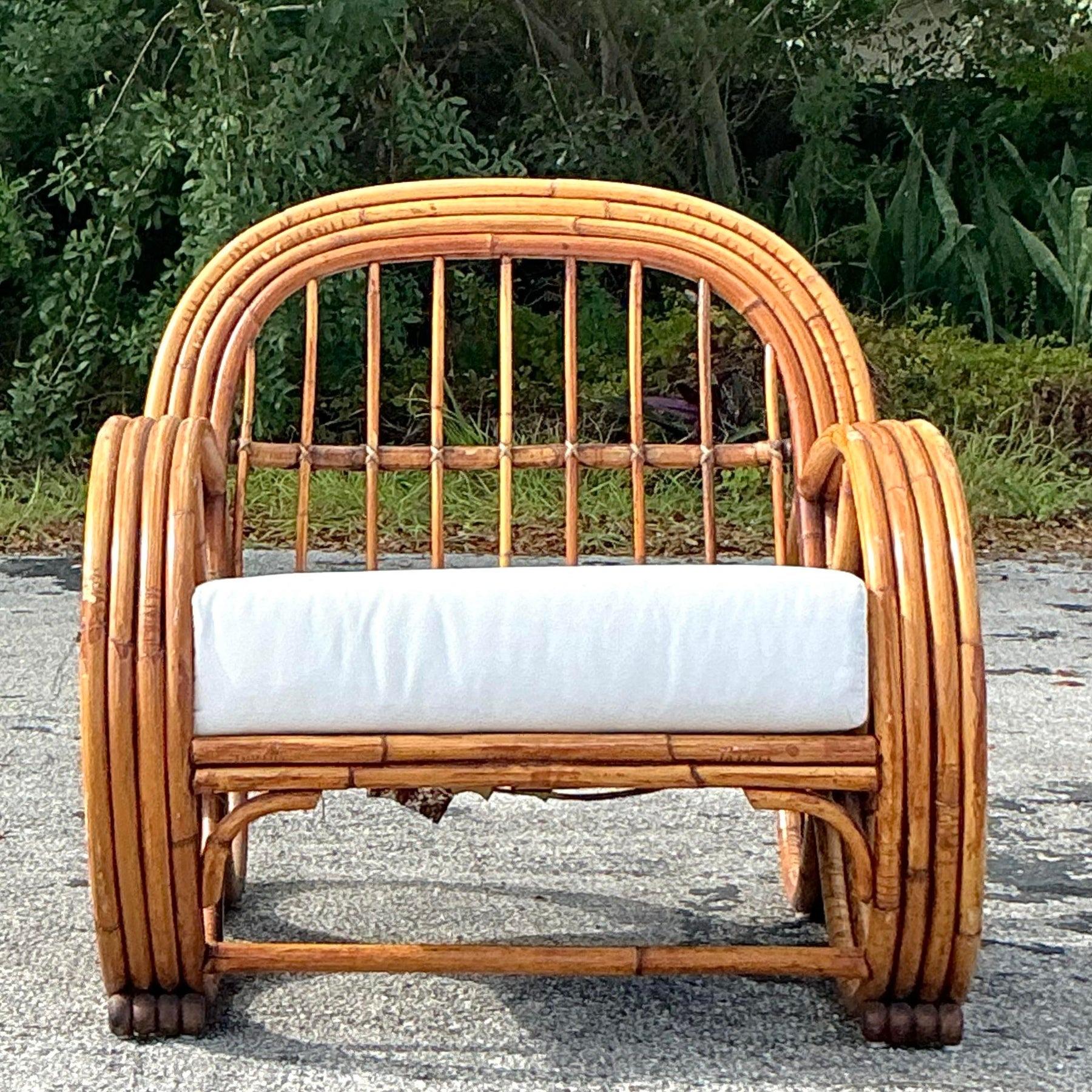 Relax in timeless style with this vintage coastal bent rattan lounge chair. Crafted with beautifully curved rattan and intricate woven accents, this chair captures the essence of coastal living. Its lightweight yet sturdy construction offers both