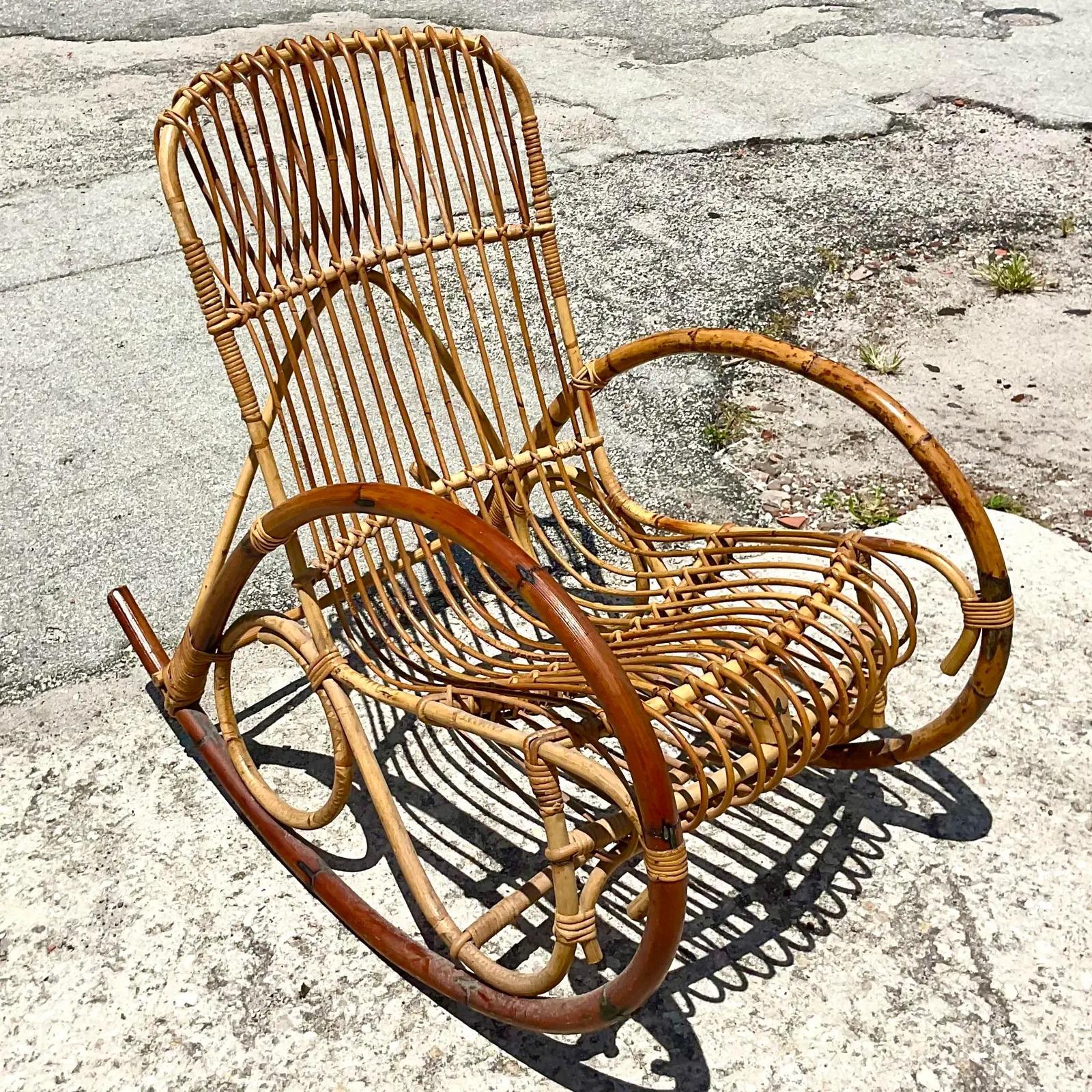 Fabulous vintage Coastal rocking chairs. Beautiful bent rattan in two shades of brown. Acquired from a Palm Beach estate.