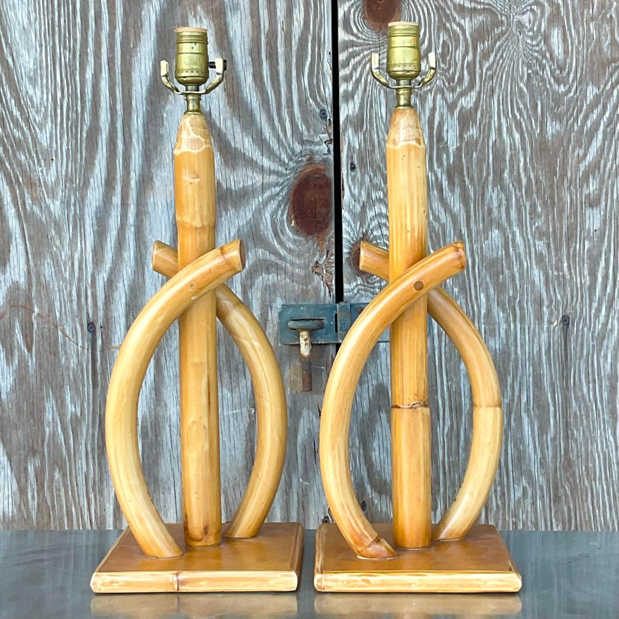 A fabulous pair of vintage Coastal table lamps. Beautiful bent rattan in a clean and modern shape. Acquired from a Palm Beach estate.
