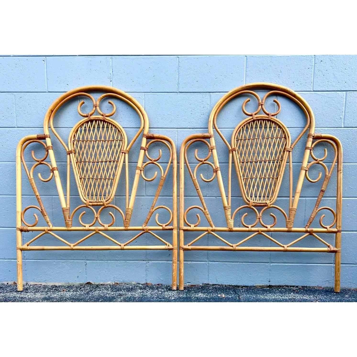Fabulous vintage coastal Twin headboards. Beautiful bent rattan in a charming swirl design. Inset panels of trellis rattan. Acquired from a Palm Beach estate.