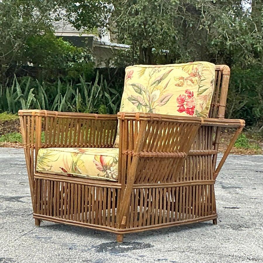 Elegant vintage coastal Bielecky Brothers stick rattan lounge chair with matching ottoman, showcasing impeccable craftsmanship and timeless design. Featuring a sturdy rattan frame, sleek lines, and plush cushions for ultimate comfort. Perfect for