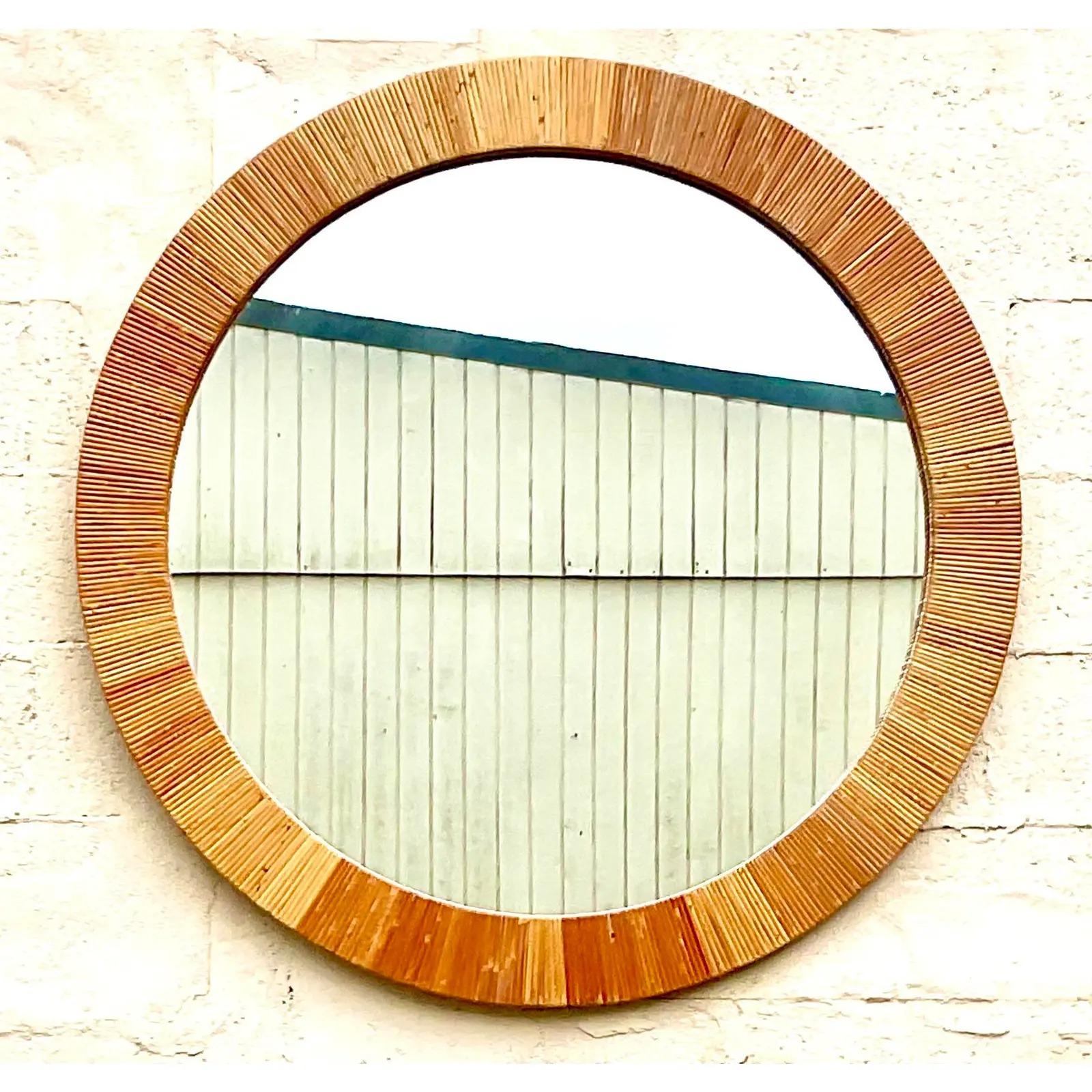 Fantastic vintage Coastal wall mirror. Made by the iconic Bielecky Brothers and tagged on the back. Beautiful wrapped rattan in a round shape. Acquired from a Palm Beach estate.