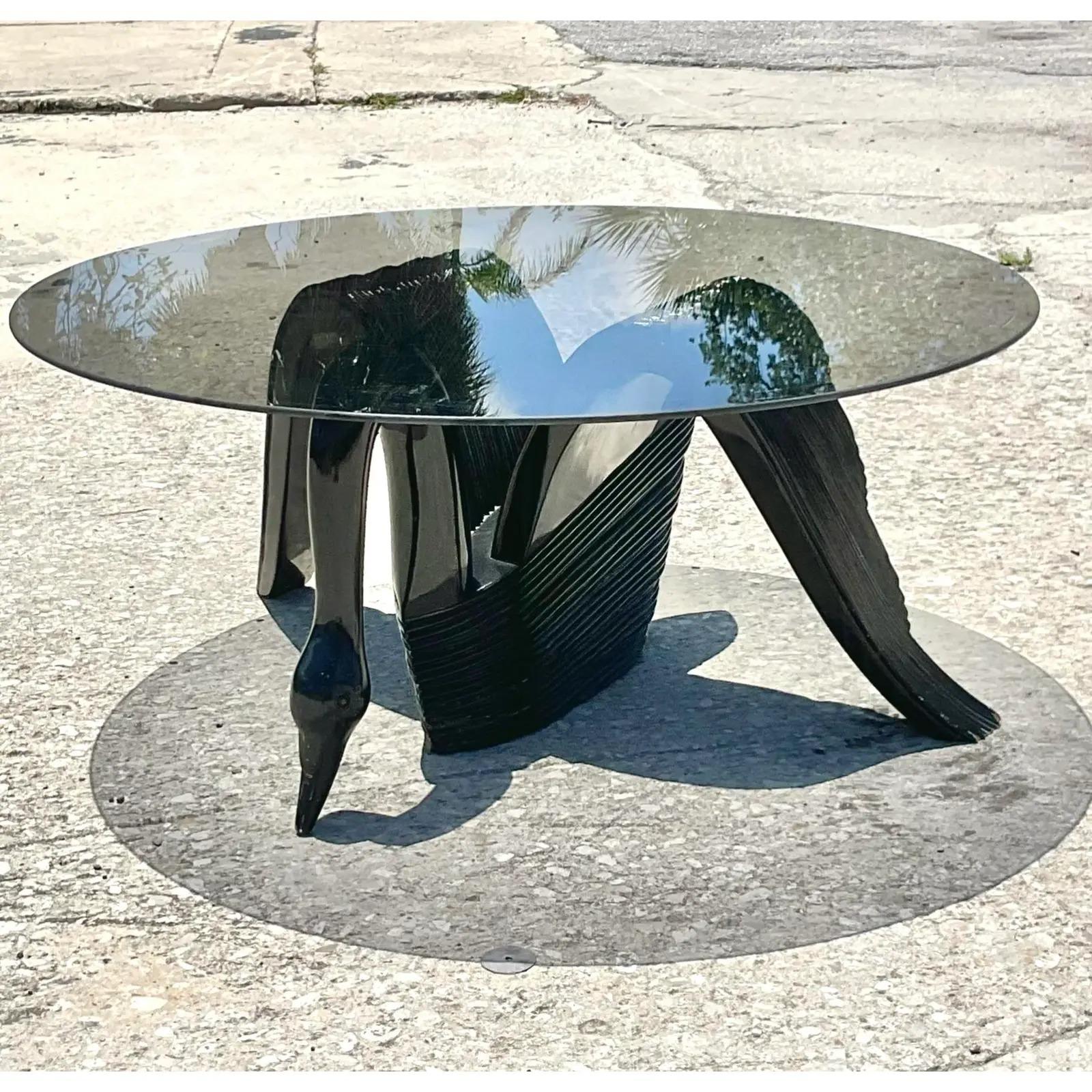 Fantastic vintage Coastal coffee table. Beautiful black lacquer high gloss finish. A fabulous swan shape with a smoked glass top. Happy to switch it out to clear glass if preferred. Acquired from a Palm Beach estate.
