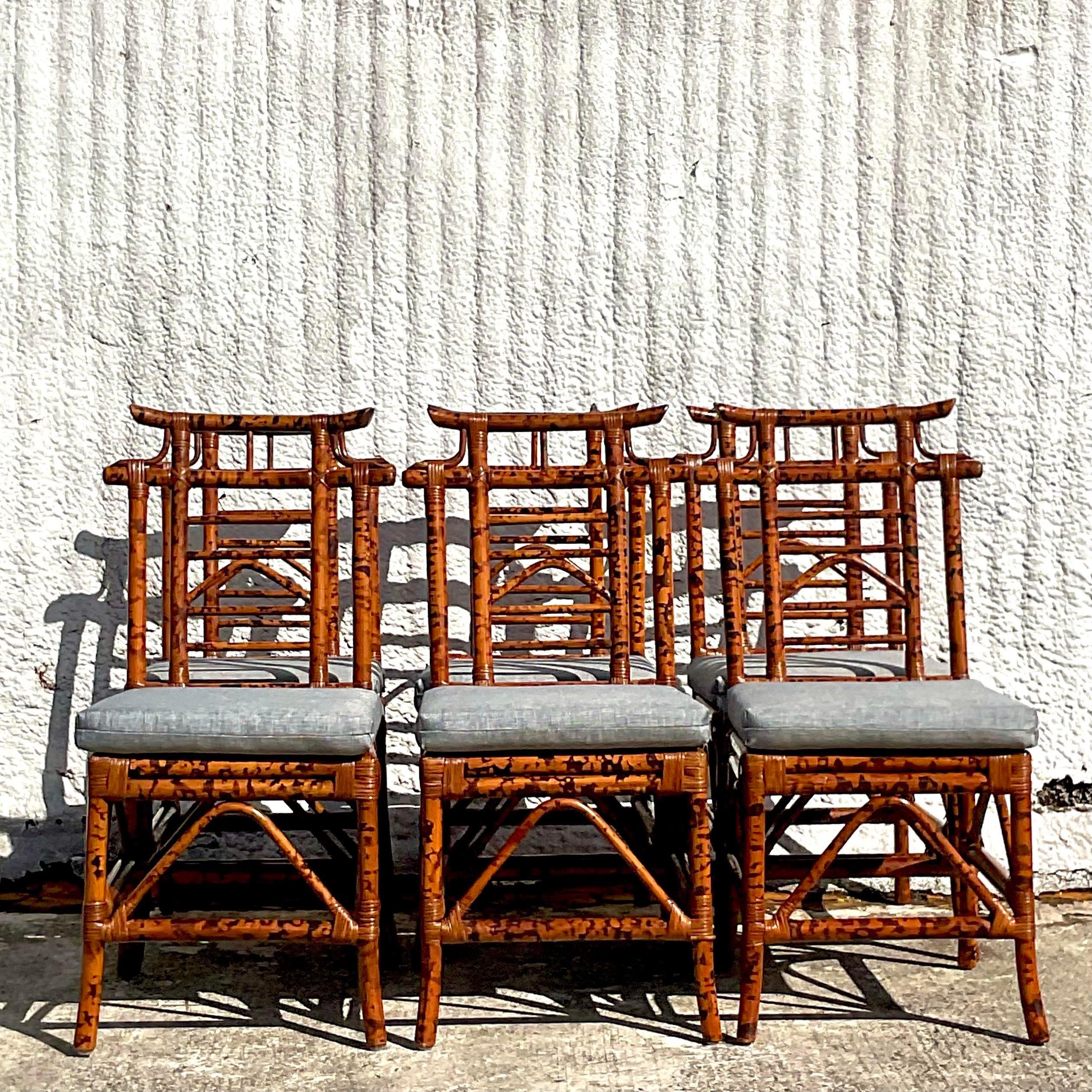A spectacular set of six vintage Coastal dining chairs. Chic pagoda style with inset cane seats. A gorgeous burnt bamboo frame with a newly upholstered loose cushion. Acquired from a Palm Beach estate.