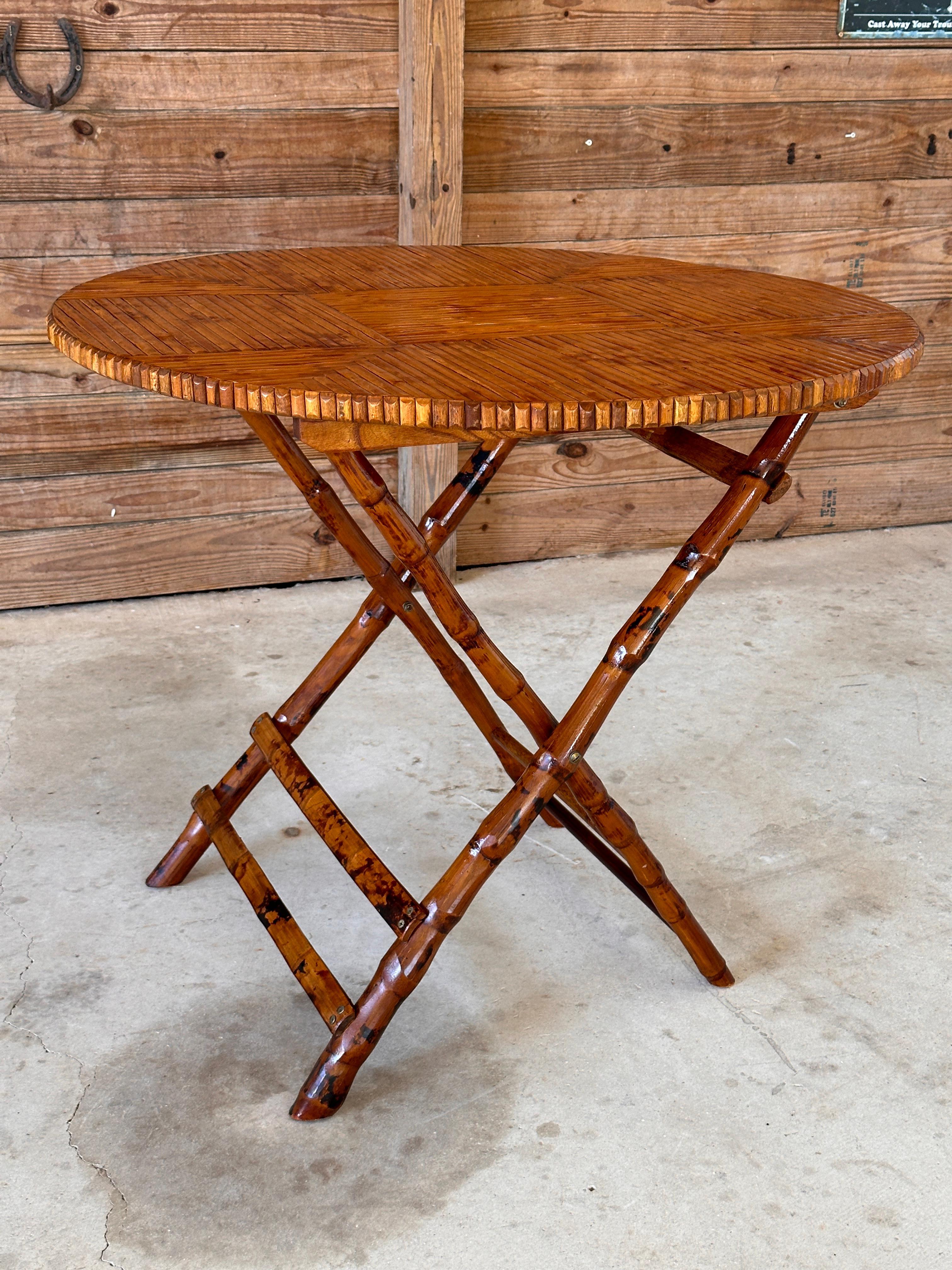 Charming vintage folding table crafted from bamboo and rattan, featuring a striking geometric parquet design on the top.
The natural beauty of the bamboo is highlighted by the warm honey finish, bringing a rustic yet refined feel to the piece. The