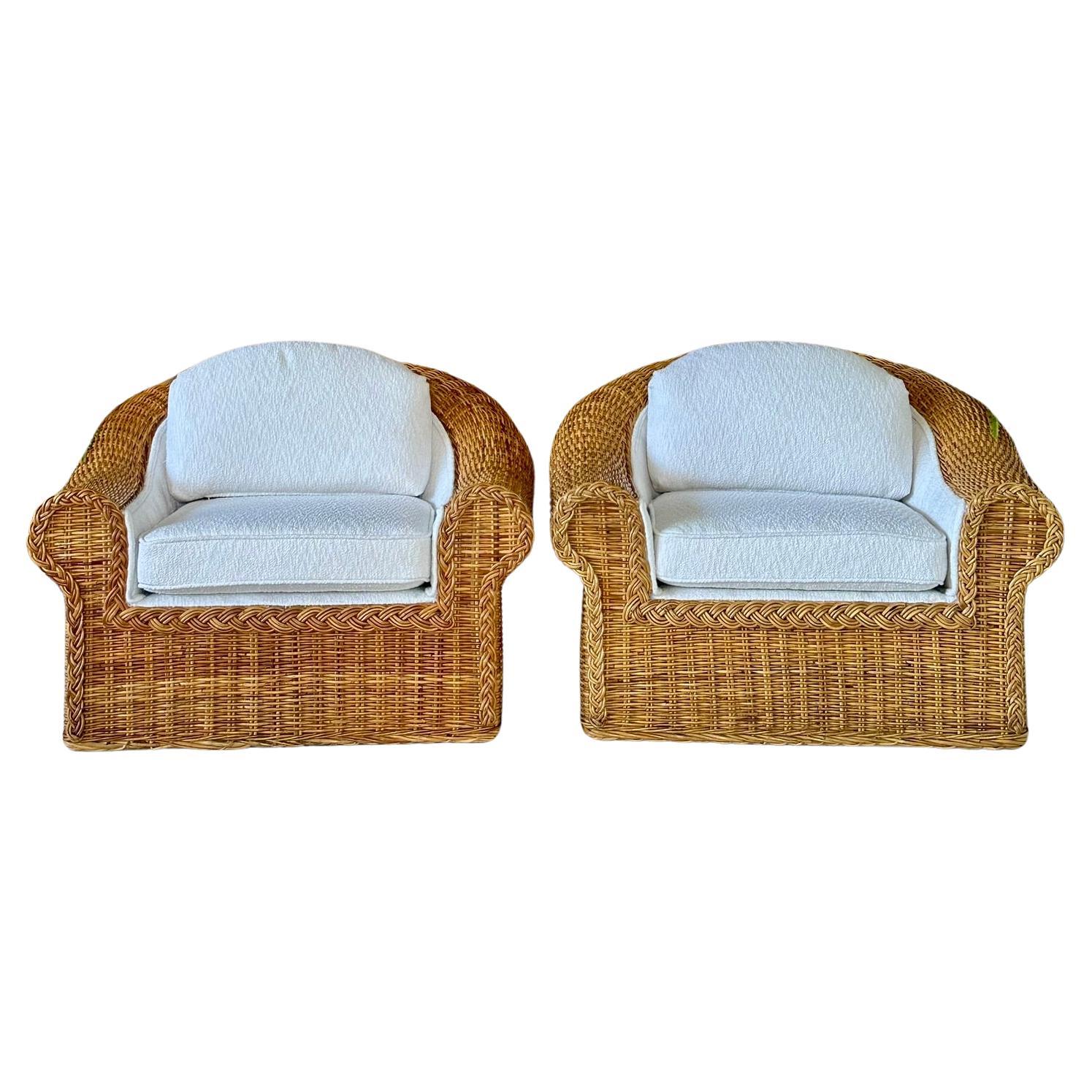 These vintage lounge chairs showcase a striking large braid rattan wicker design with a protruding flair back, exuding timeless rustic charm. Updated with new custom textured white Sunbrella fabric, they blend classic elegance with modern