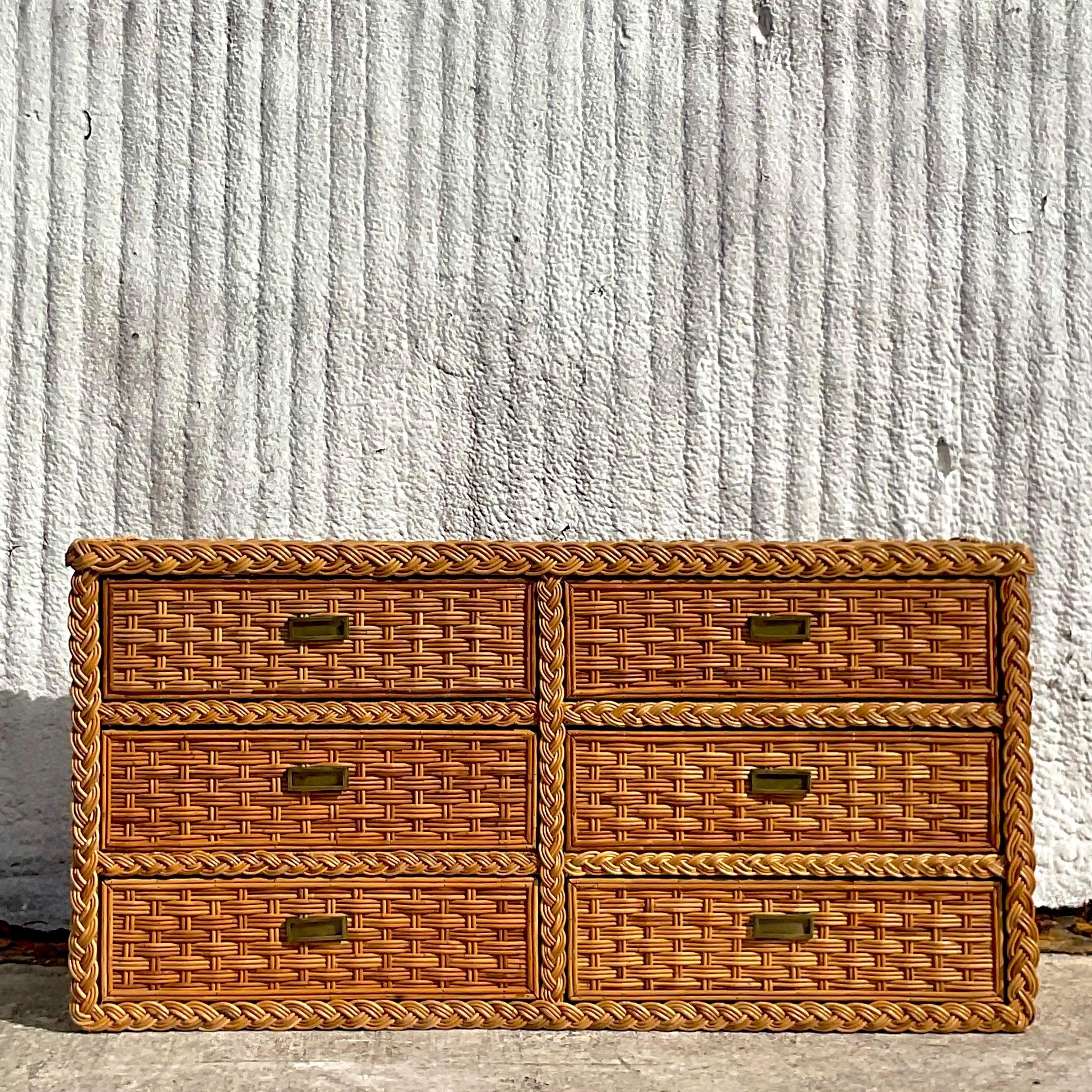 A fantastic vintage Coastal rattan dresser. A chic braided rattan motif with a beautiful patina from time. Coordinating nightstands also available on my page. Acquired from a Palm Beach estate. 