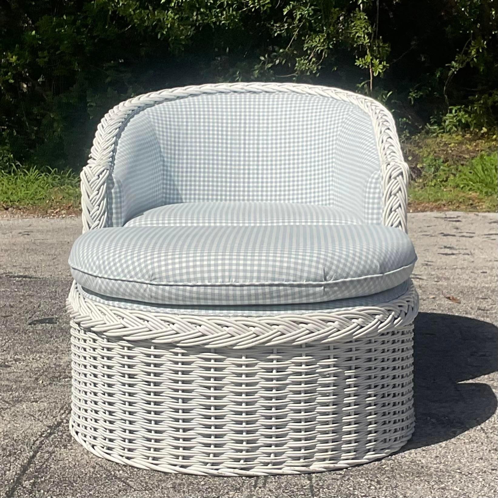 Transport yourself to seaside serenity with this Vintage Coastal Braided Rattan Lounge Chair and Ottoman. Crafted with meticulous attention to detail, this iconic duo epitomizes classic American coastal style. The intertwining rattan exudes natural