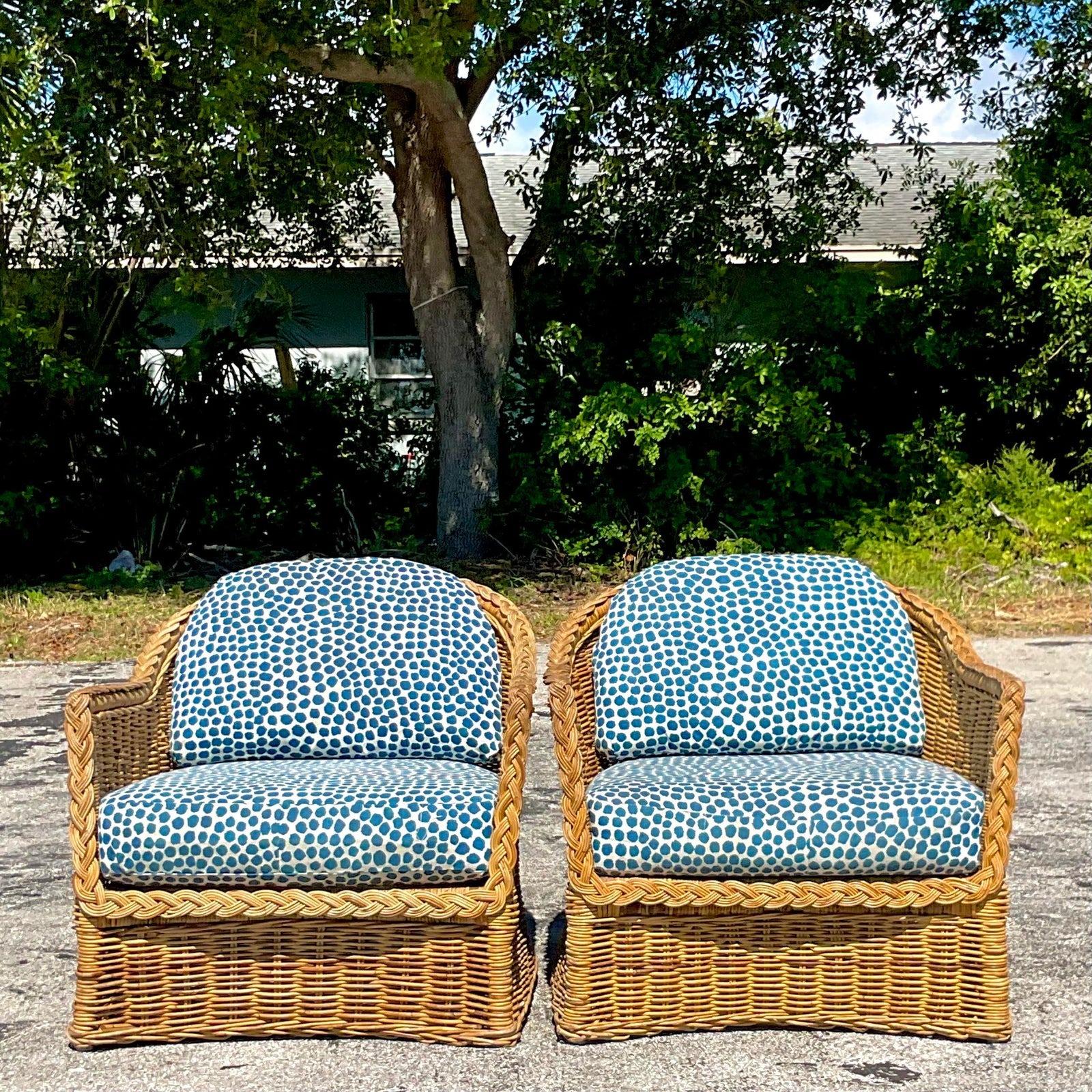 A fabulous pair of vintage Coastal lounge chairs. Gorgeous braided rattan with a wide seat design. Charming dot upholstery. Acquired from a Palm Beach estate.