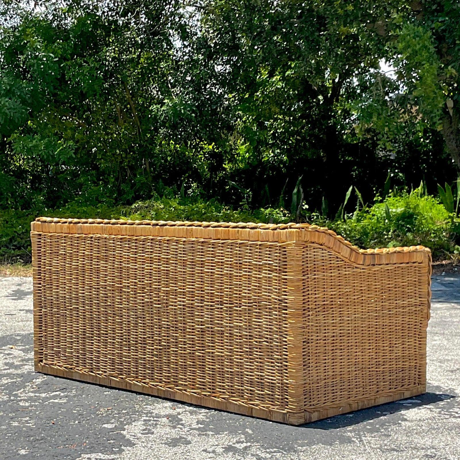 A fabulous vintage Coastal rattan sofa. A chic braided rattan along a woven rattan frame. Acquired from a Palm Beach estate.