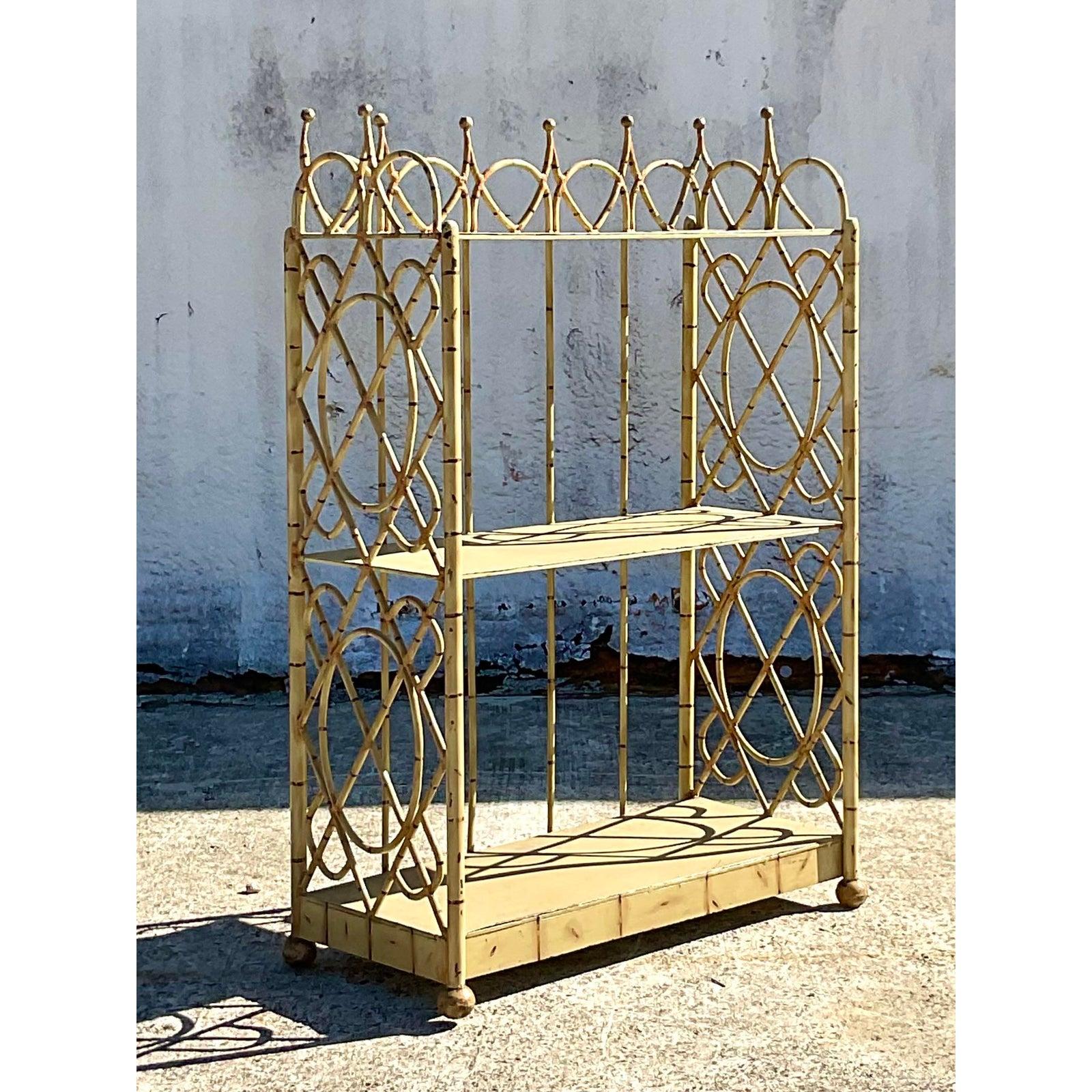 Fantastic vintage distressed metal bookcase. A beautiful gable design crafted by the iconic Briger Design group. A favorite among designers in the know. Chic distressed finish. Unmarked. Acquired from a Palm Beach estate.