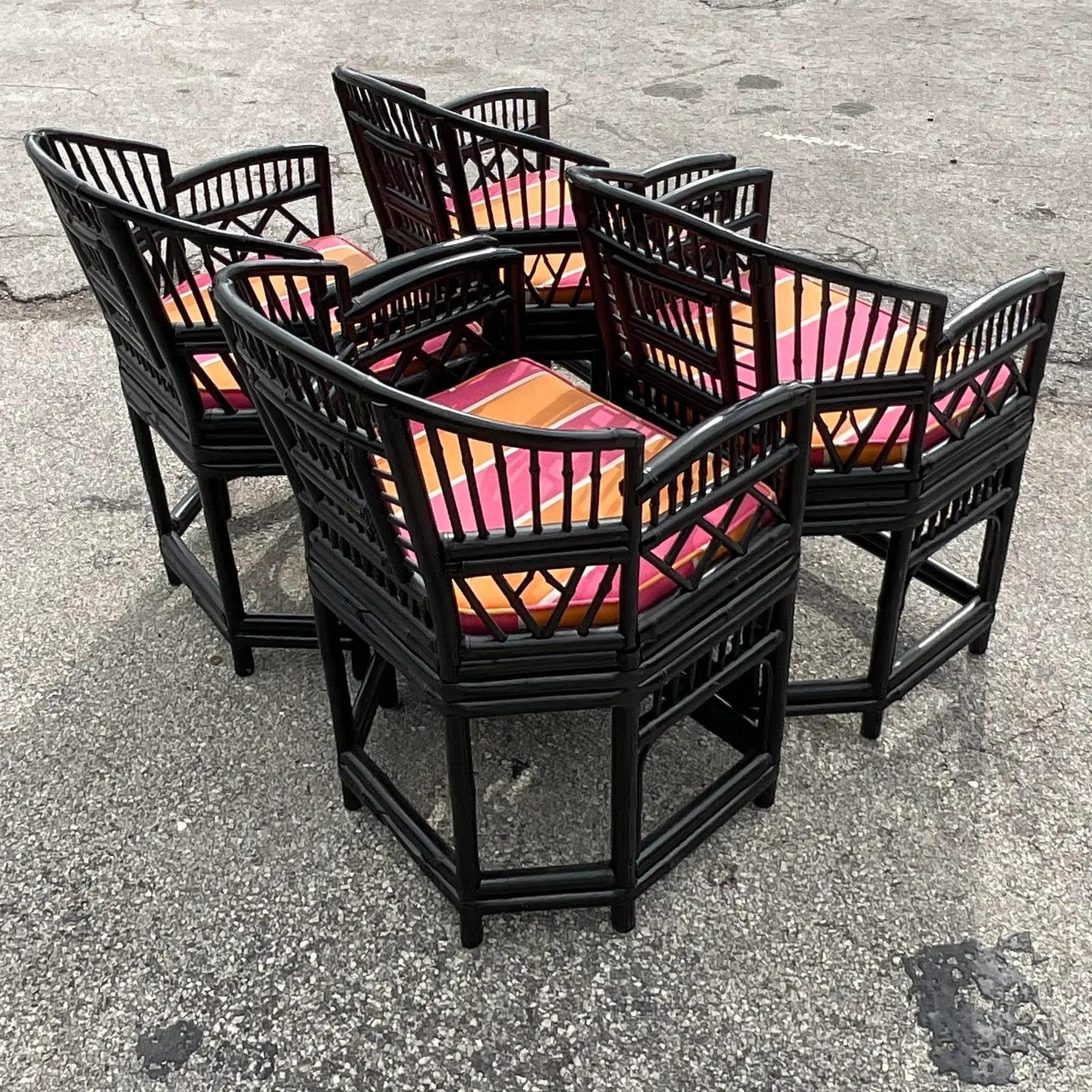 A fantastic set of 4 vintage Coastal dining chairs. Chic Brighton Pavilion design painted a semi gloss black. Bright upholstered seats that can be removed to reveal an inset cane panel. Acquired from a Palm Beach estate.