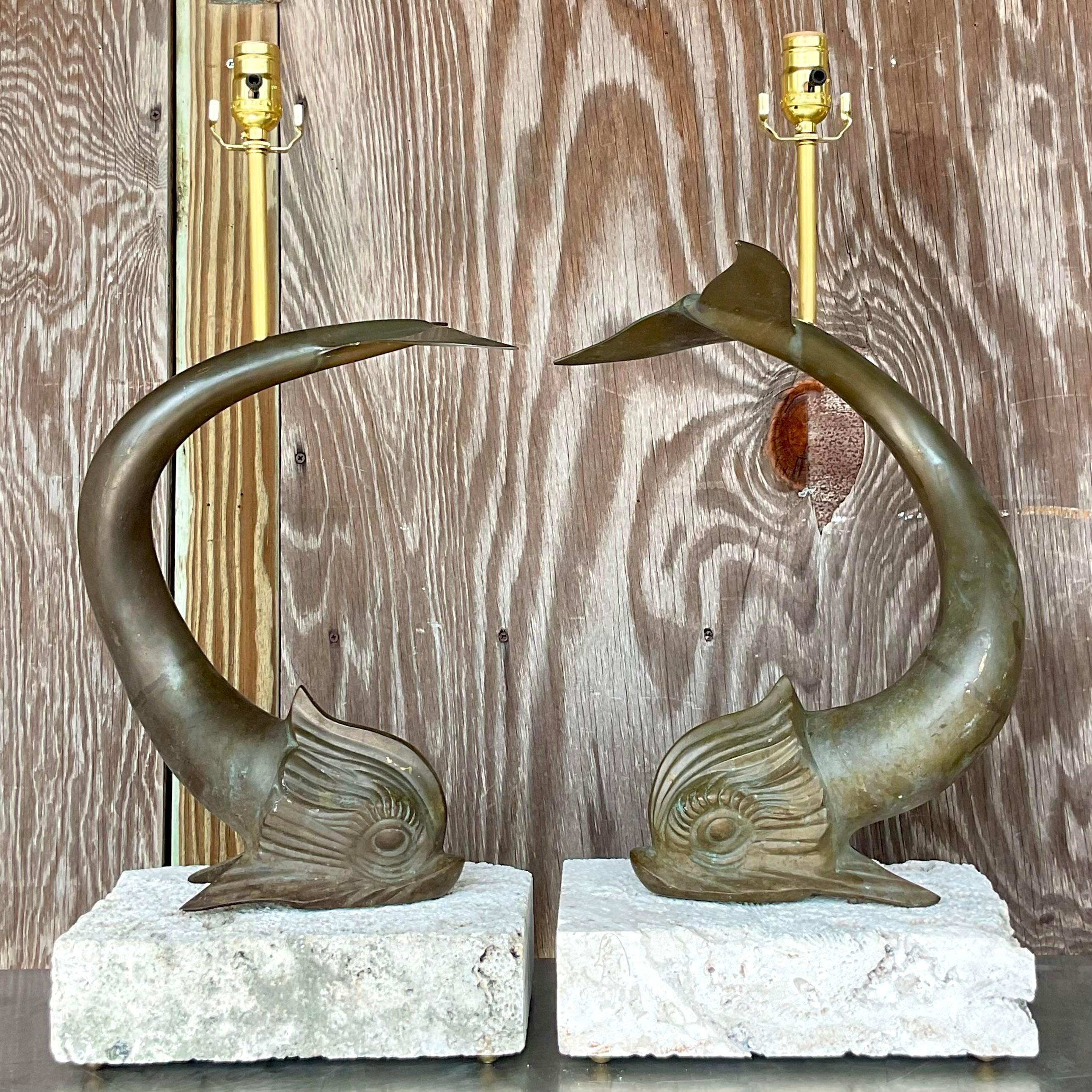 A remarkable pair of vintage Costal table lamps. A chic bronze Koi fish mounted on custom coquina block plinths. All new wiring and hardware. Acquired from a Palm Beach estate.