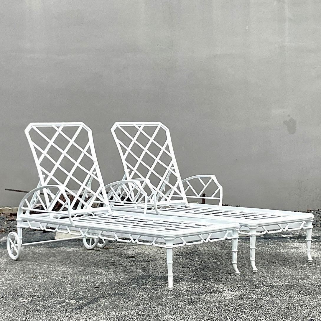 A fabulous pair of vintage Coastal wrought iron chaise lounges. Made by the iconic brown Jordan group and tagged on the back. Beautiful gloss white in the classic design. Acquired from a Palm Beach estate.