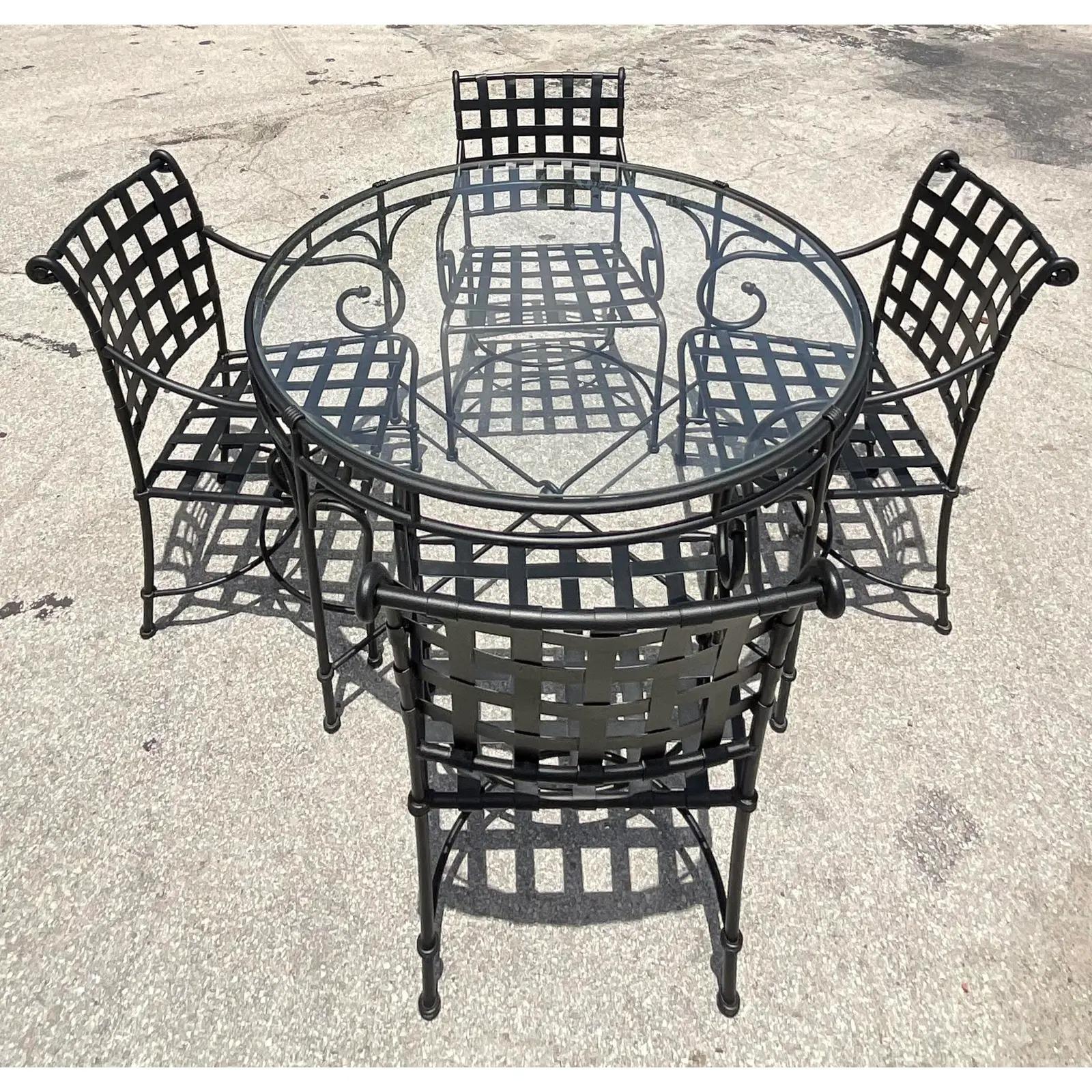 Fantastic set of four vintage Brown Jordan dining chairs and matching table. The highly coveted Florentine set done in black wrought iron. Inset glass dining table. Unmarked. Acquired from a Palm Beach estate.

Dining table dimensions 49x49x29.5.