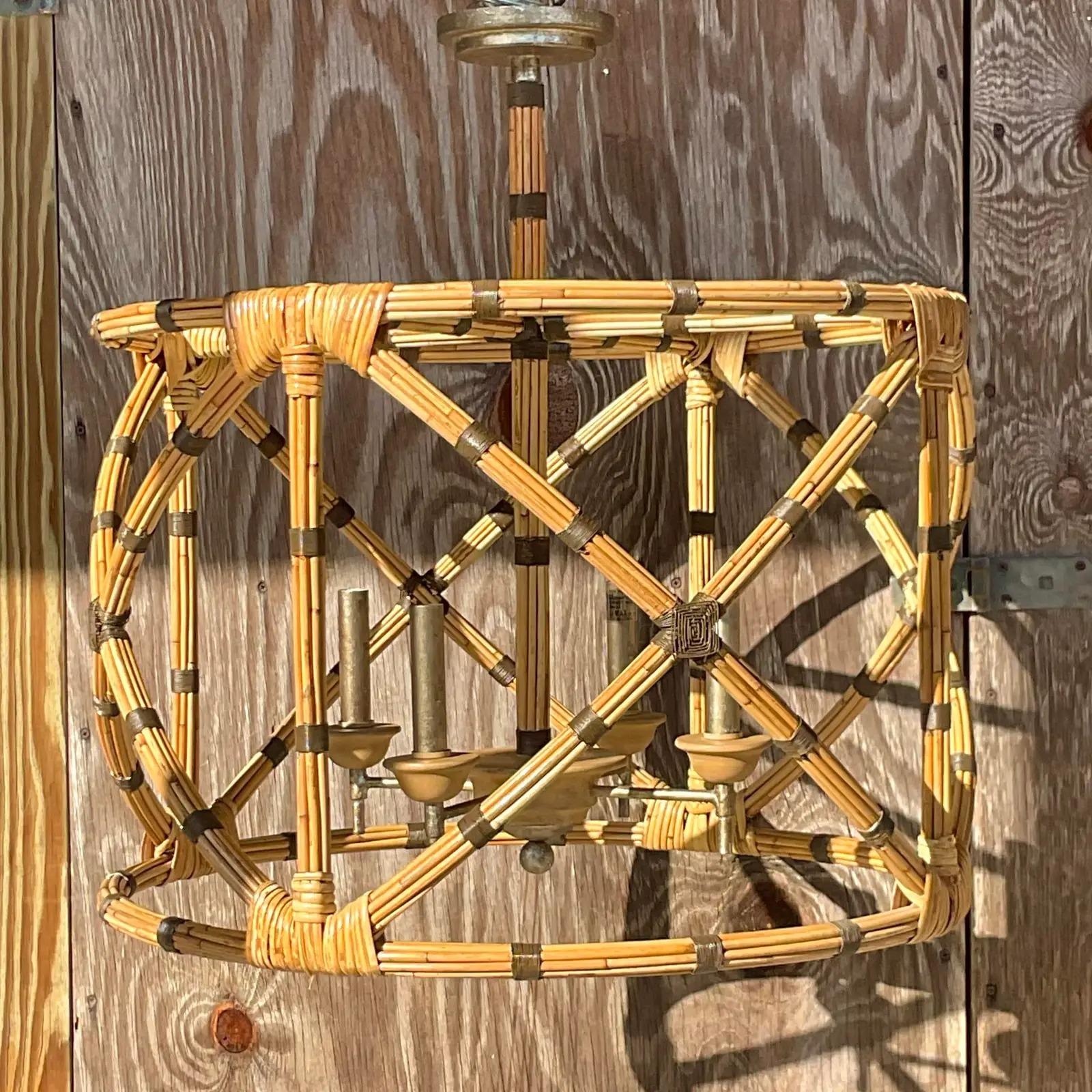 A fantastic vintage Coastal chandelier. Made by the iconic Currey and Co. beautiful bundled rattan with chic wire wraps at the joints. Acquired from a Palm Beach estate.
