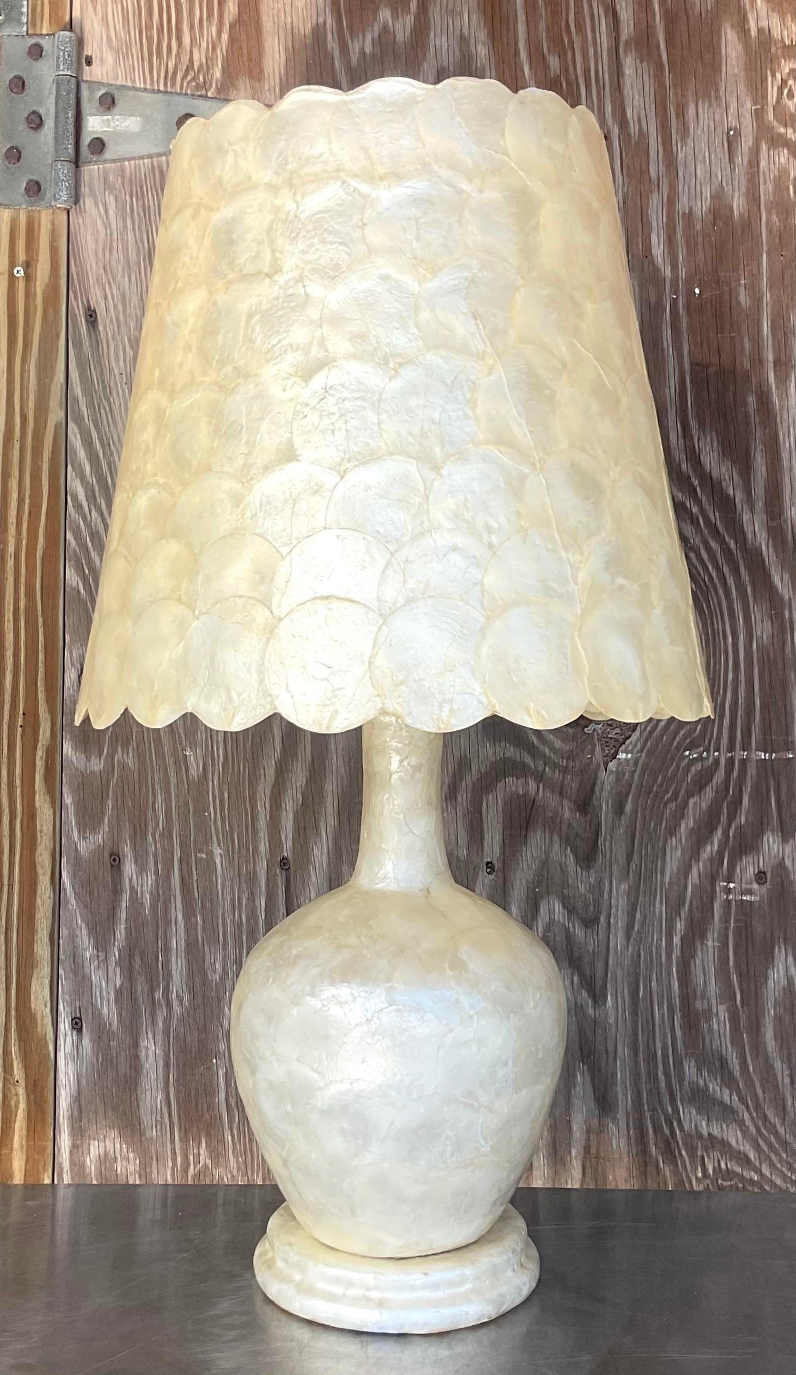 A fabulous vintage Costal table lamp. A stunning Capiz Shell Finnish with a coordinating scalloped shade. Acquired from a Palm Beach estate.