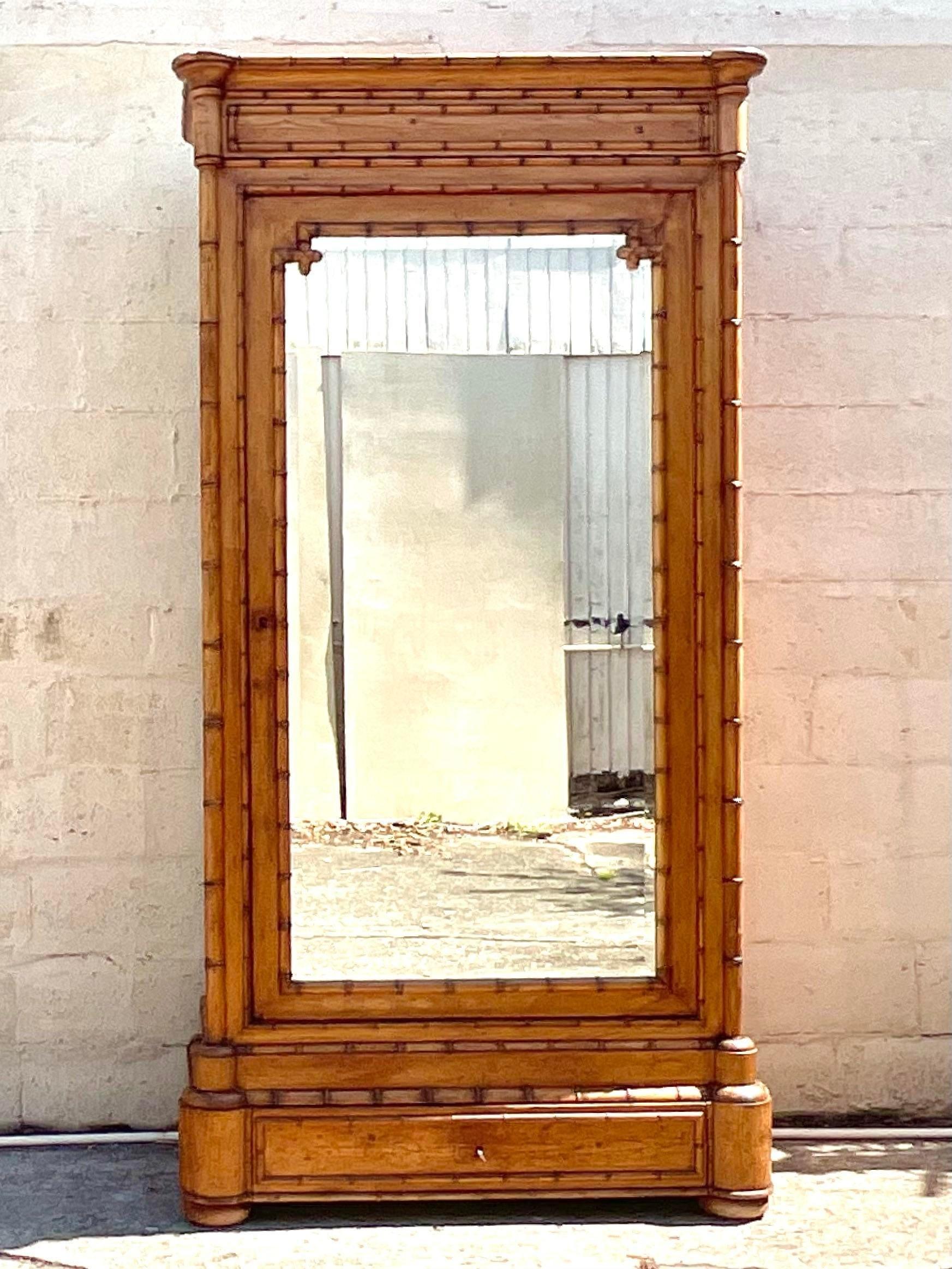 Embrace the breezy elegance of coastal living with this Vintage Carved Bamboo Armoire. Expertly crafted with intricate detailing, this American-made piece offers ample storage and a touch of seaside charm, making it a stylish and functional addition