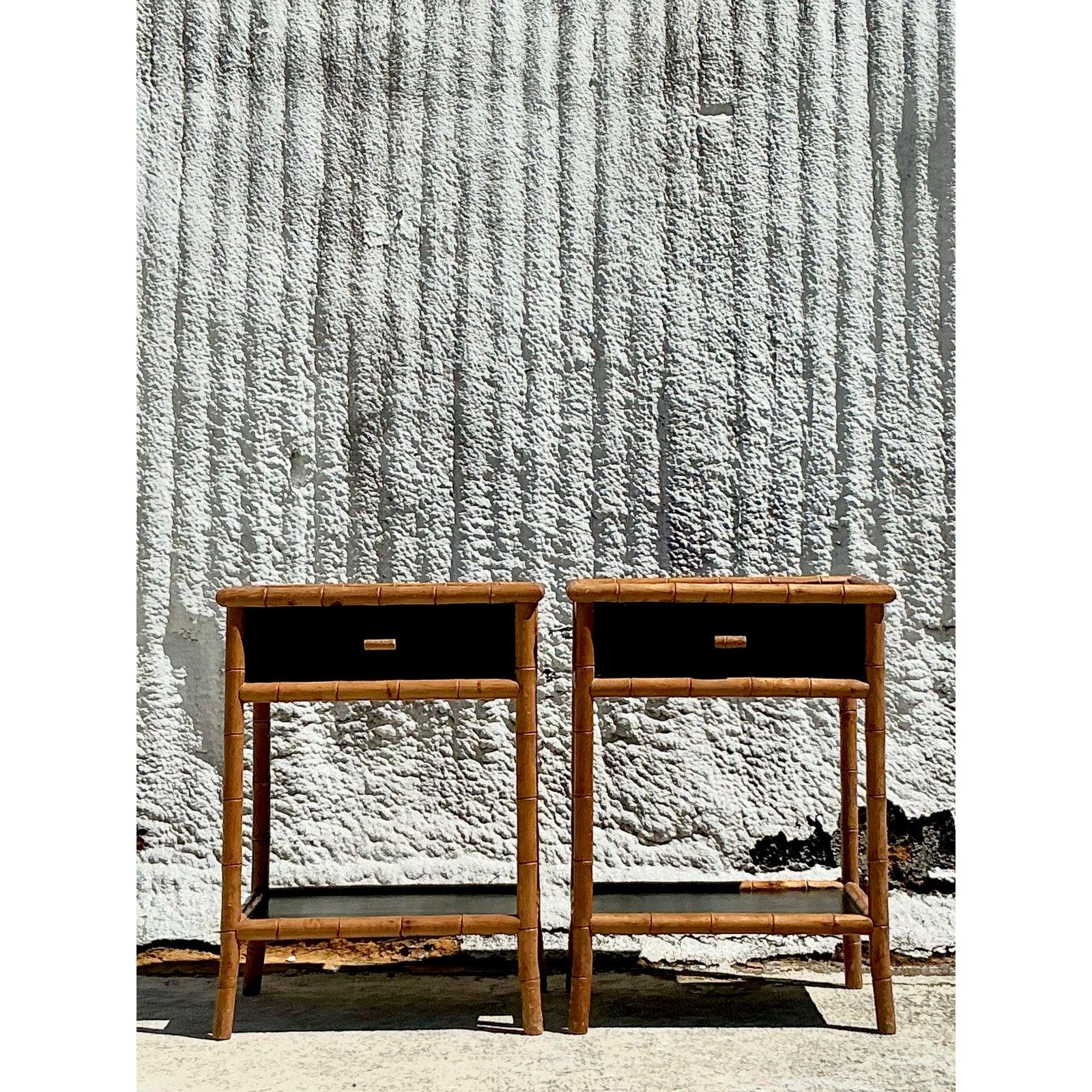 Infuse your space with timeless coastal charm with this pair of vintage carved bamboo nightstands. These exquisite pieces showcase beautifully detailed bamboo frames, blending organic textures with a sleek black lacquered top and drawer front for a