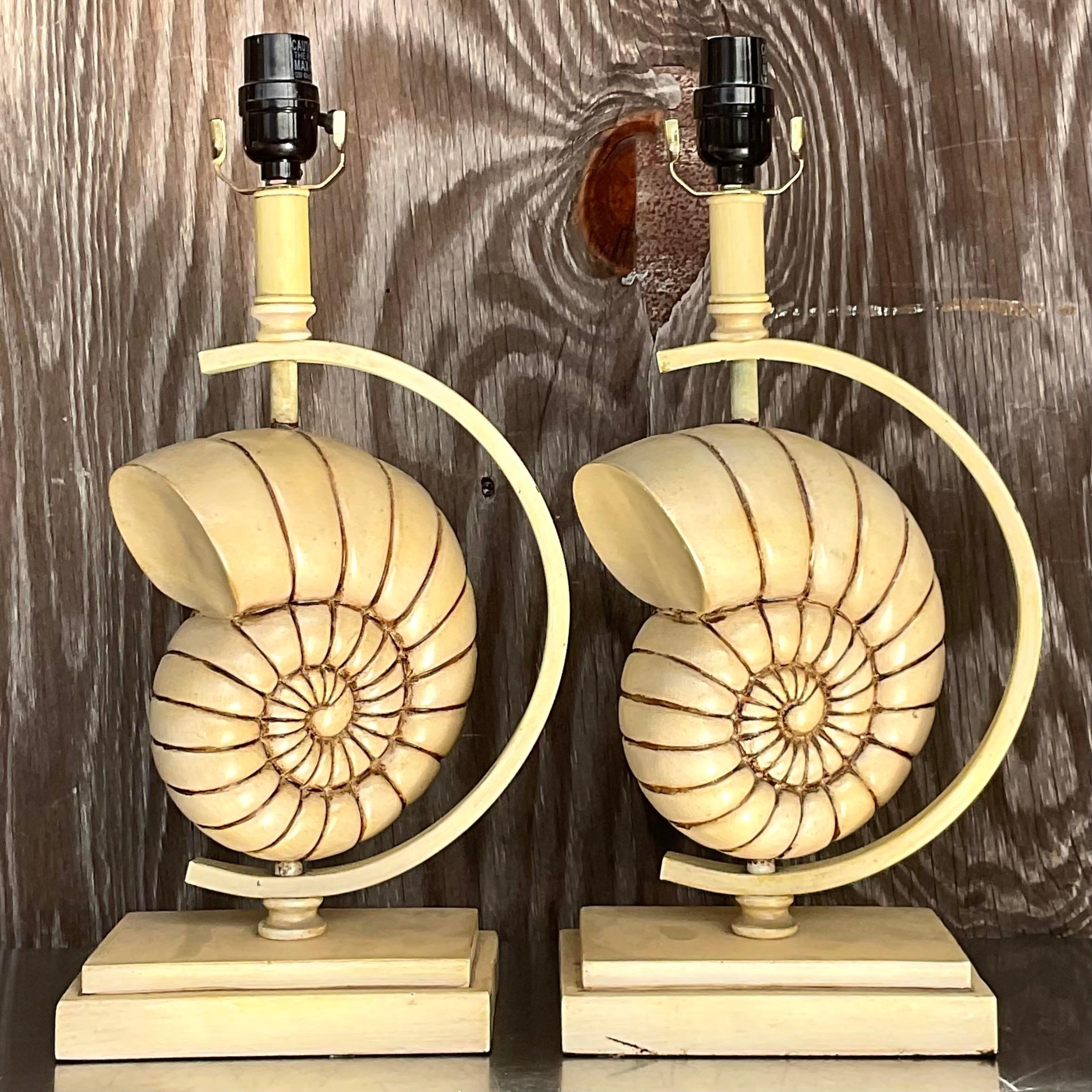 A fabulous pair of vintage Coastal table lamps. A chic carved nautilus shell that’s spins inside a metal frame. Acquired from a Palm Beach estate.