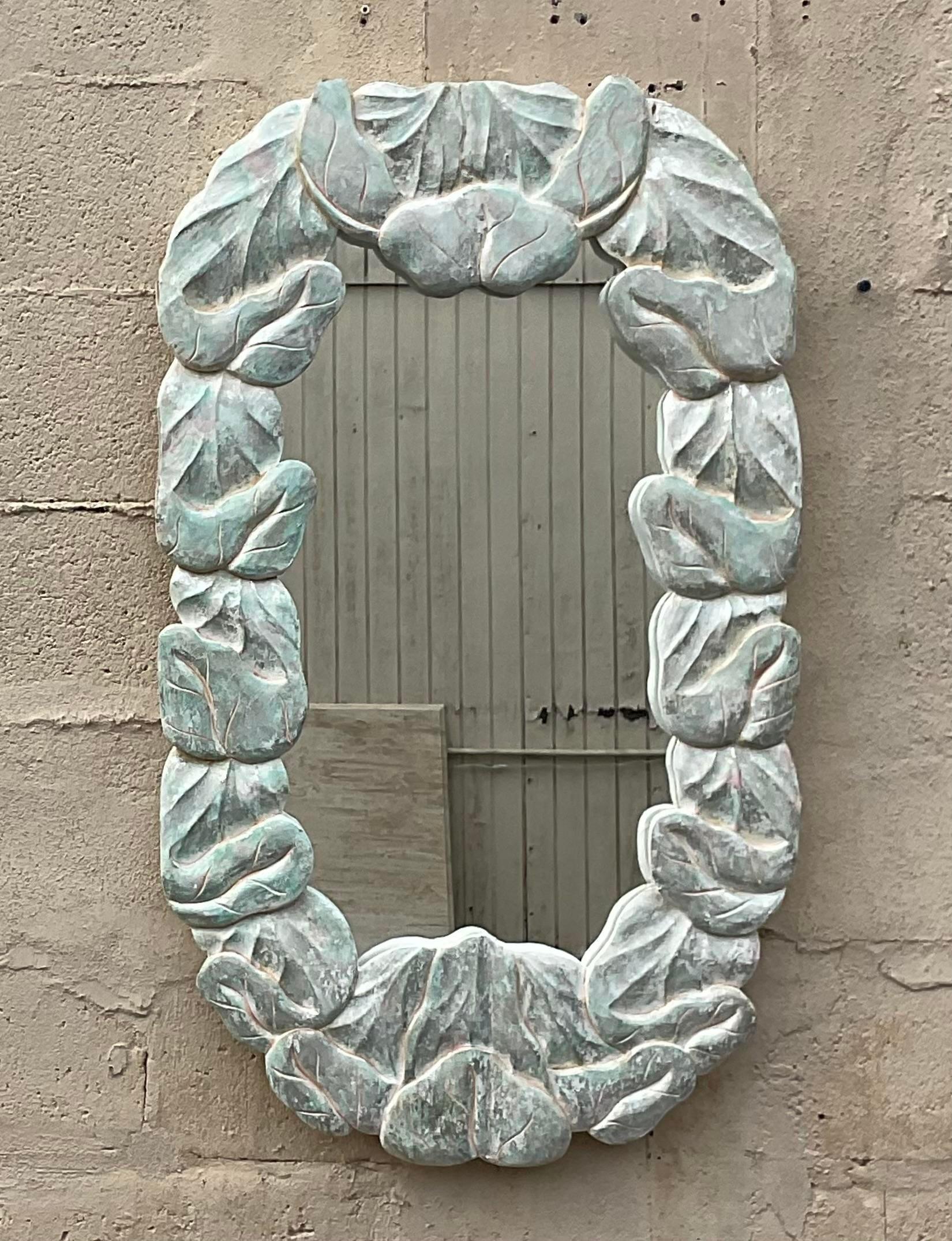 Evoke the timeless beauty of coastal Americana with this vintage carved wood wrapped leaves mirror. Each intricately crafted detail reflects the essence of craftsmanship rooted in tradition. A captivating blend of natural elements and rustic charm,