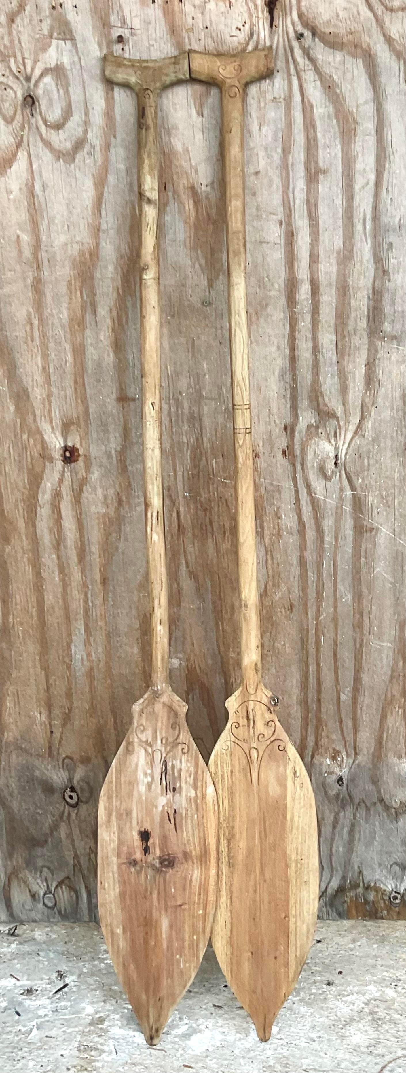 A fabulous pair of vintage coastal Oars. A chic hand carved design with beautiful rustic handles. Gorgeous on the wall or in a vessel. You decide! Acquired from a Palm Beach estate.