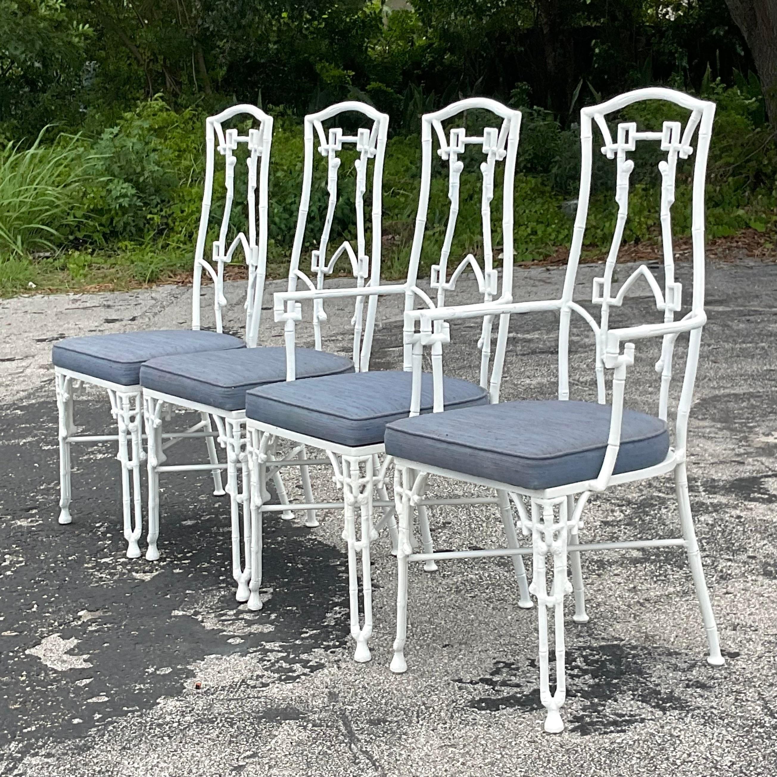 Set of 4 midcentury cast aluminum dining chairs. Hollywood regency faux bamboo detail, with open fretwork design. Done in the manner of Kessler Industries. Matching table also available on my page. Acquired from a Palm Beach estate.

Seat height