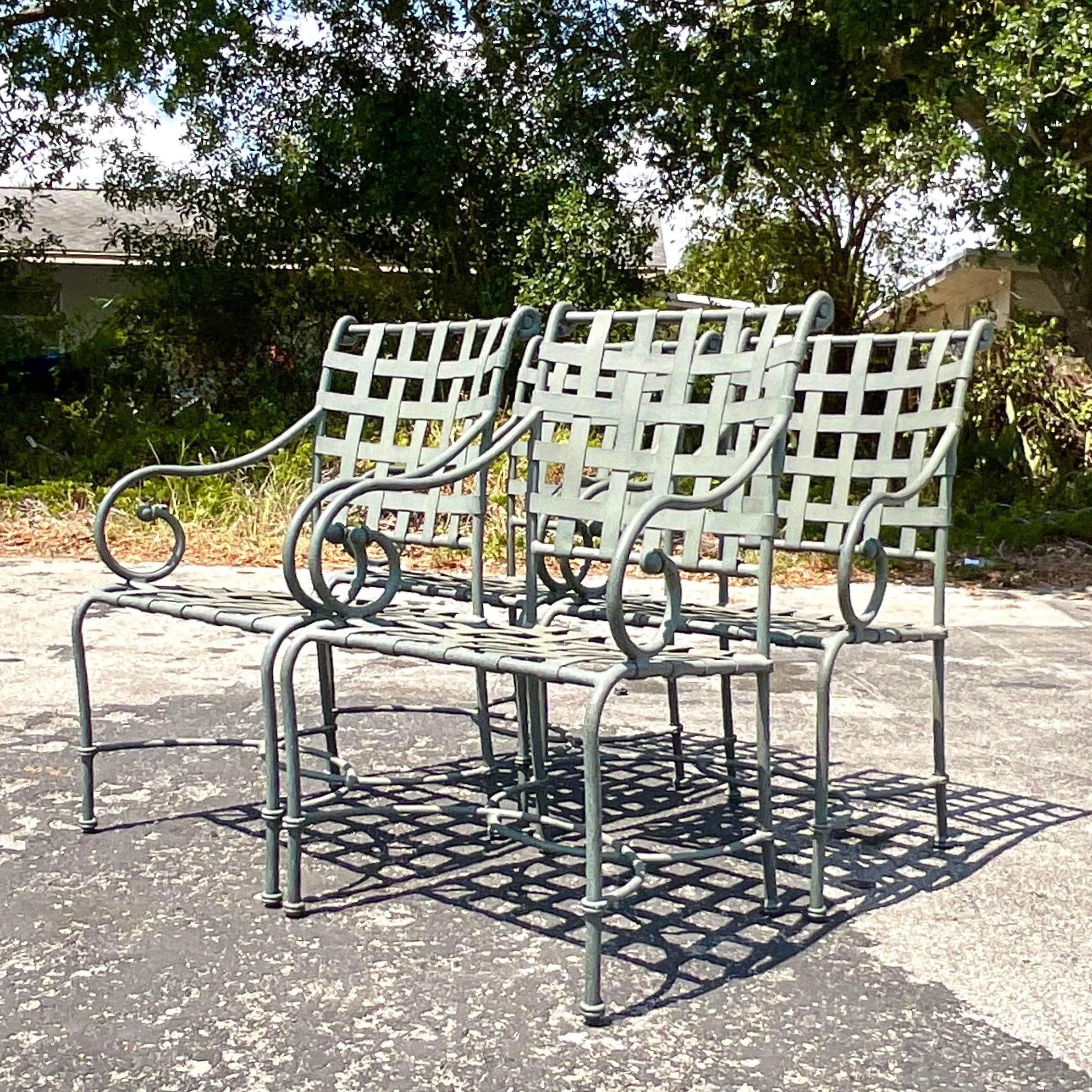 A fantastic vintage Coastal outdoor dining set. Made by the iconic Brown Jordan group. The popular Venetian collection in cast aluminum. Four arm chairs and one glass top dining table. Acquired from a Palm Beach estate.