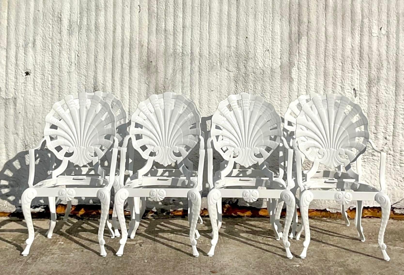 A fabulous set of 8 vintage coastal outdoor dining chairs. Done in the manner of a Brown Jordan The iconic Grotto chairs in the classic shell design. Fully restored with all new gloss white powder coating and seat panels. Fresh and ready for you to