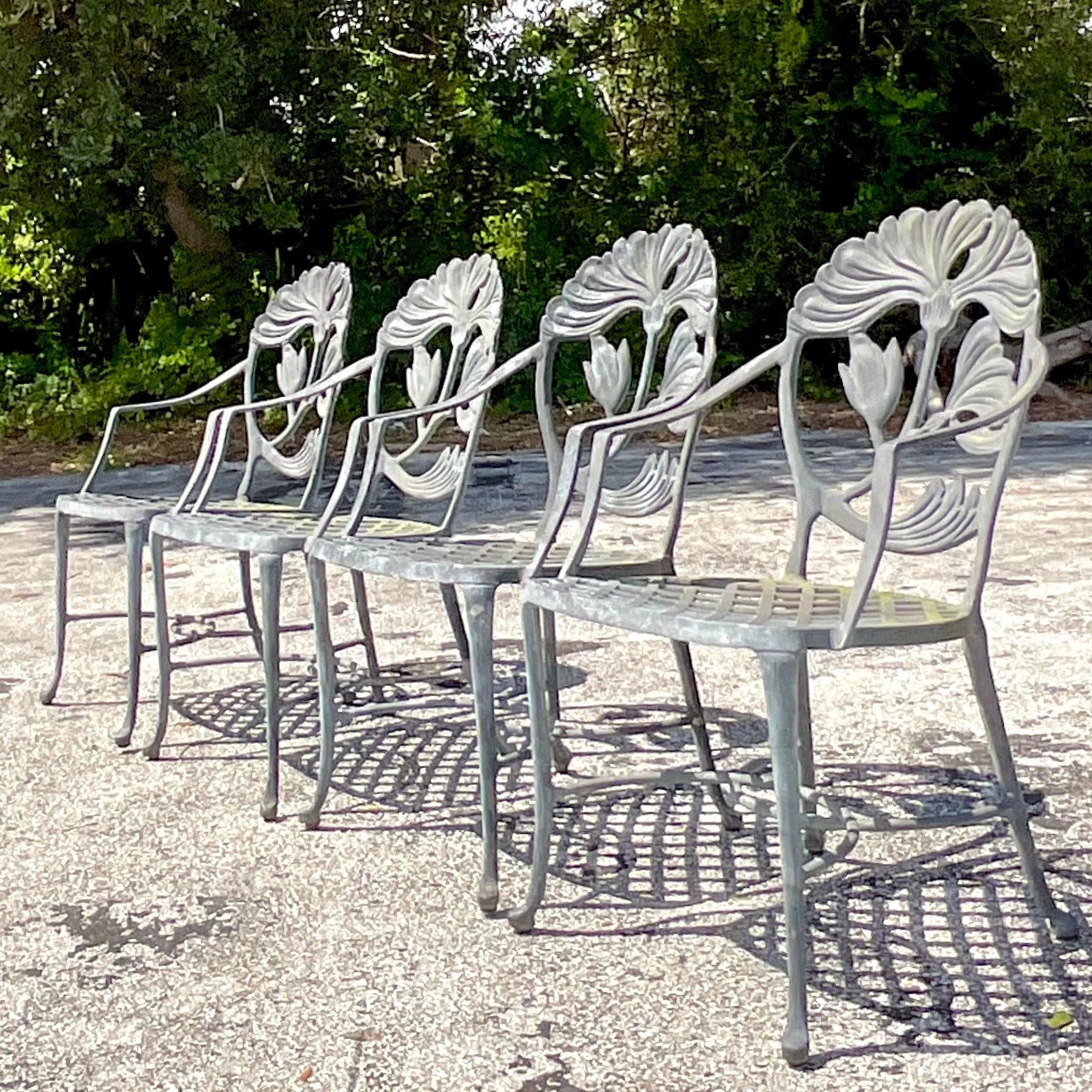 A stunning set of four vintage outdoor dining chairs. Made in a cast aluminum with is lightweight and great for properties near salt water. A beautiful lily design on the back of each chair. Coordinating table also available on my page.