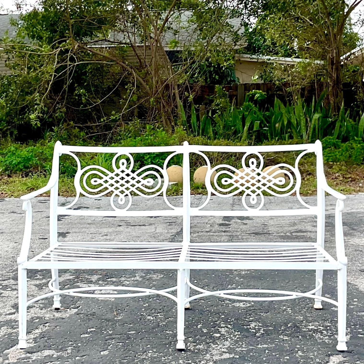 A fabulous vintage Coastal outdoor loveseat. A chic loop design in a cast aluminum frame. Acquired from a Palm Beach estate.