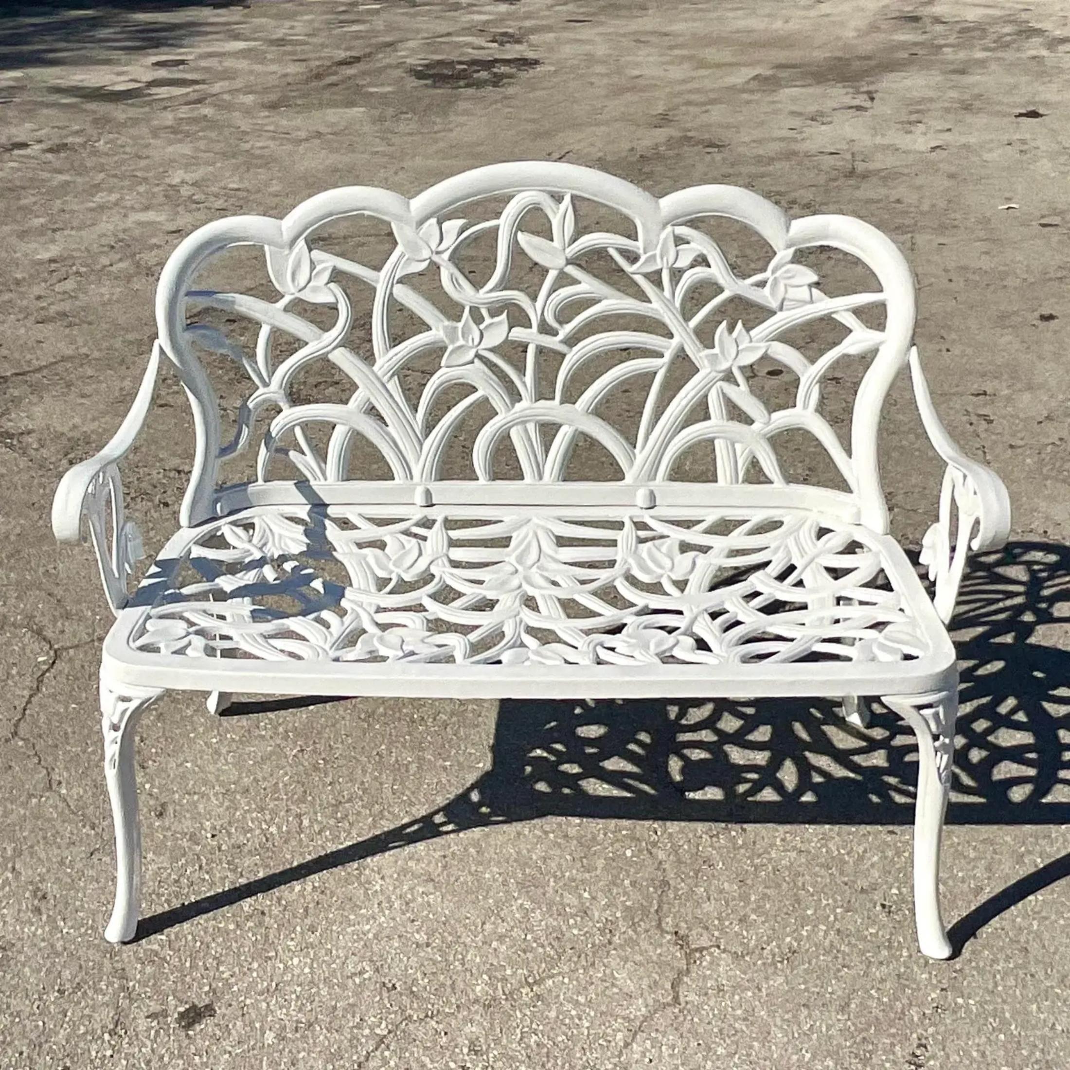 A fantastic vintage Coastal settee. A beautiful cast aluminum frame in a chic floral design. Fully restored with all new powder coating. Acquired from a Palm Beach estate