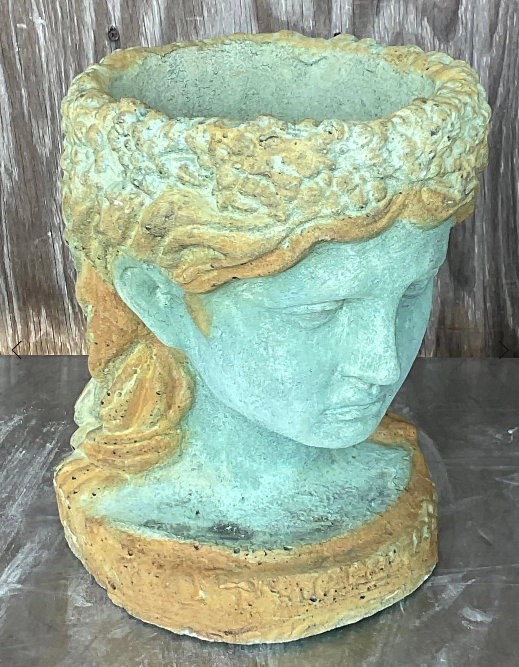 Add a touch of coastal allure to your garden with this Vintage Coastal Cast Cement Female Head Planter. Crafted with meticulous detail, this charming planter captures the essence of seaside beauty, offering a unique and stylish way to showcase your