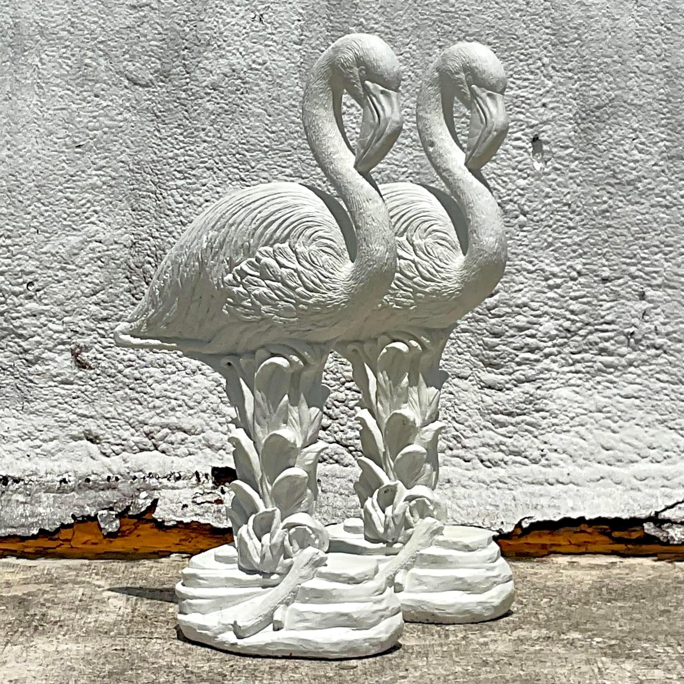 A fabulous pair of vintage Coastal statues. Chic cast concrete flamingos in a matte white finish. Perfect indoors or outside. Acquired from a Palm Beach estate.