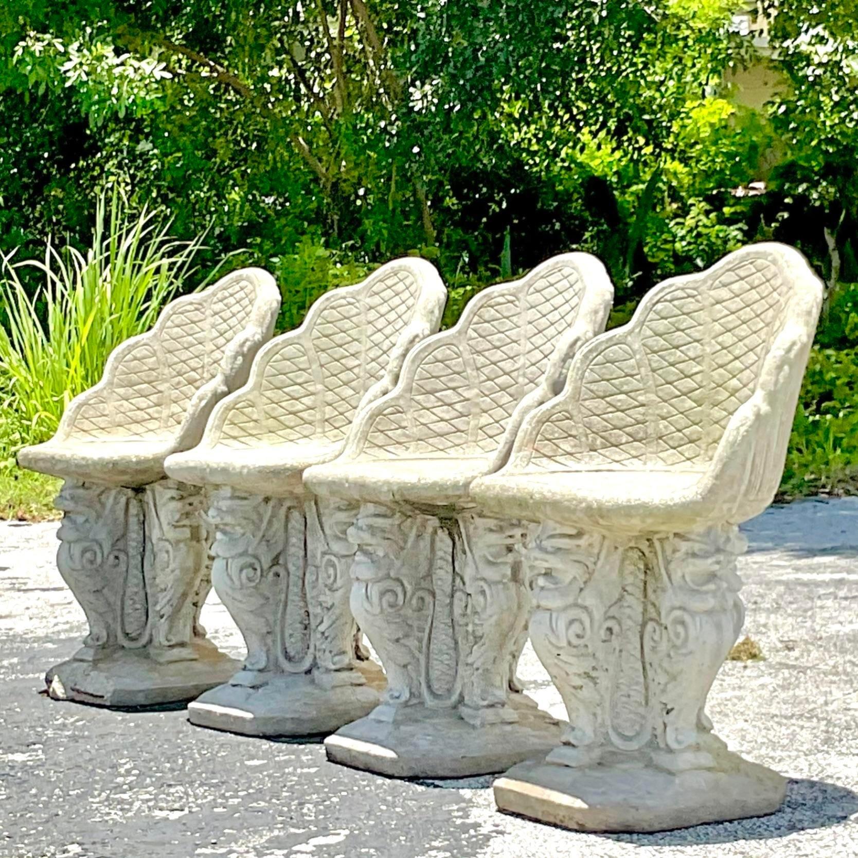 A fantastic set of four vintage Coastal dining chairs. The iconic Grotto style with serpent pedestals. Acquired from a Palm Beach estate